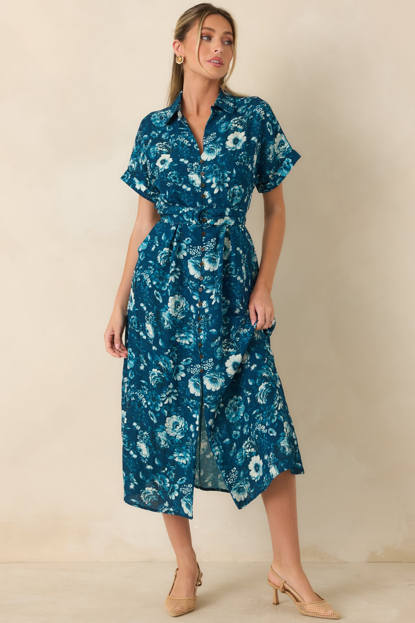 Blue multicolor floral print dress showcasing a pull-through belt, functional pockets, and relaxed silhouette.