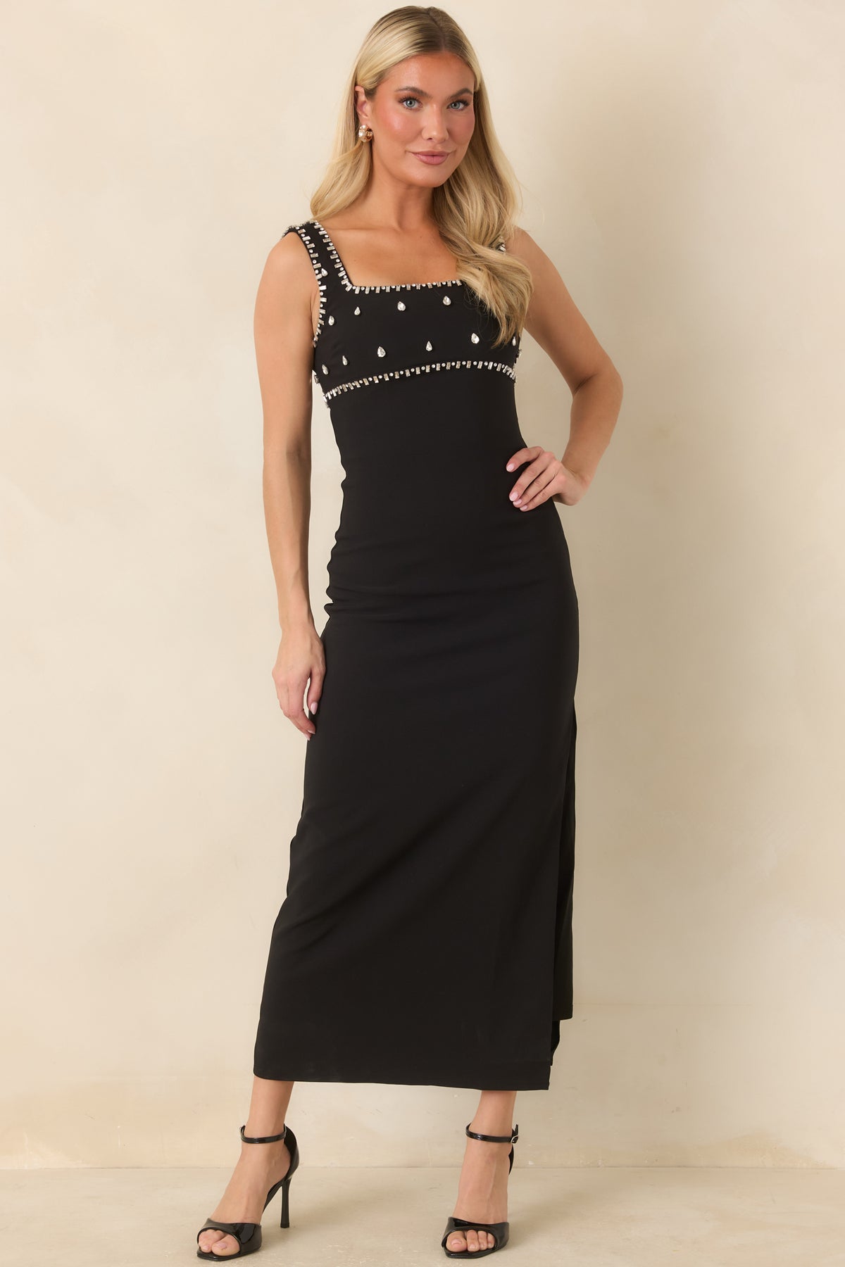Fitted midi dress showcasing teardrop rhinestone embellishments across the front bodice and sleek skirt.