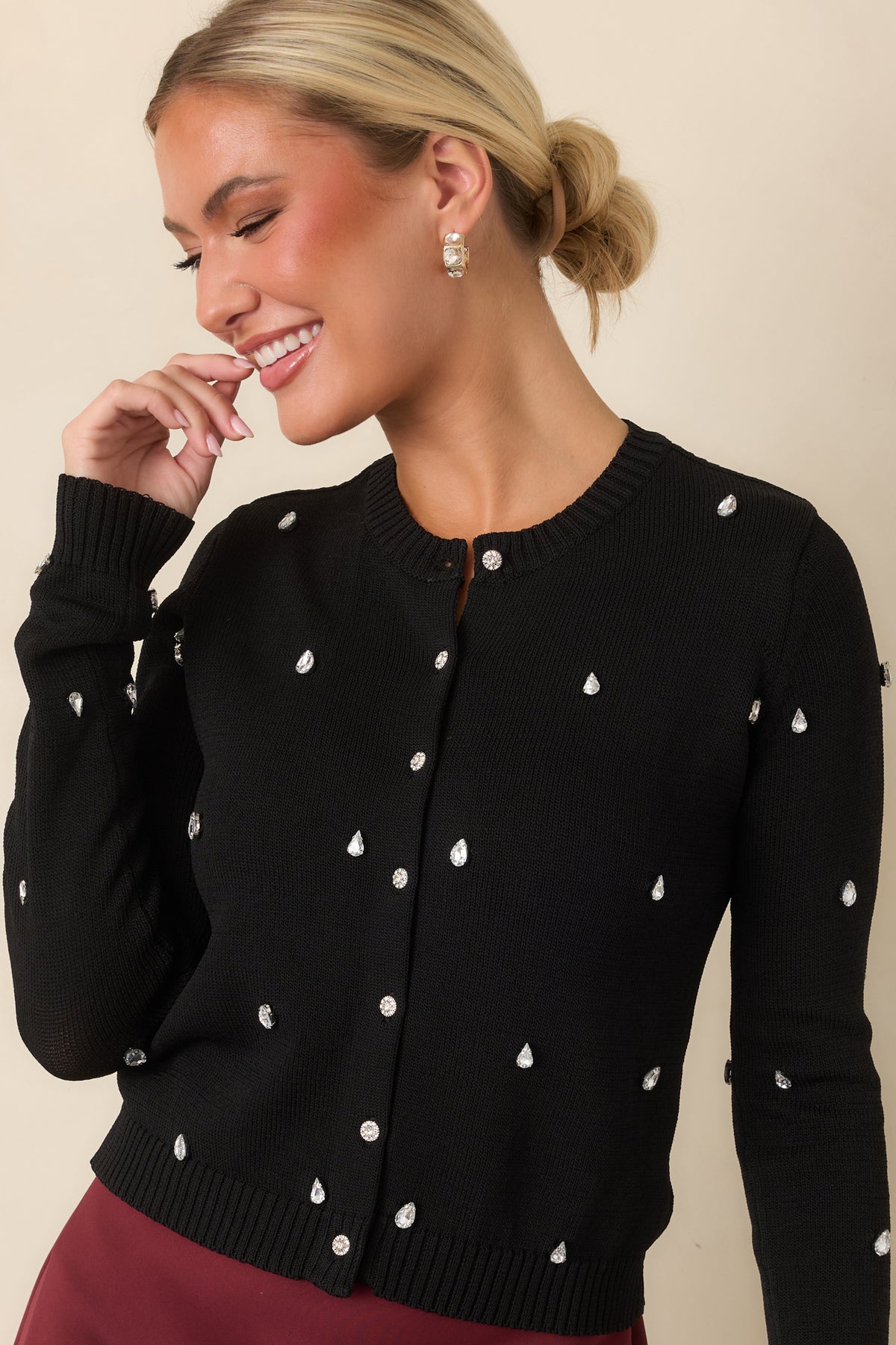 Cardigan showcasing teardrop-shaped rhinestones scattered across the front and long sleeves.