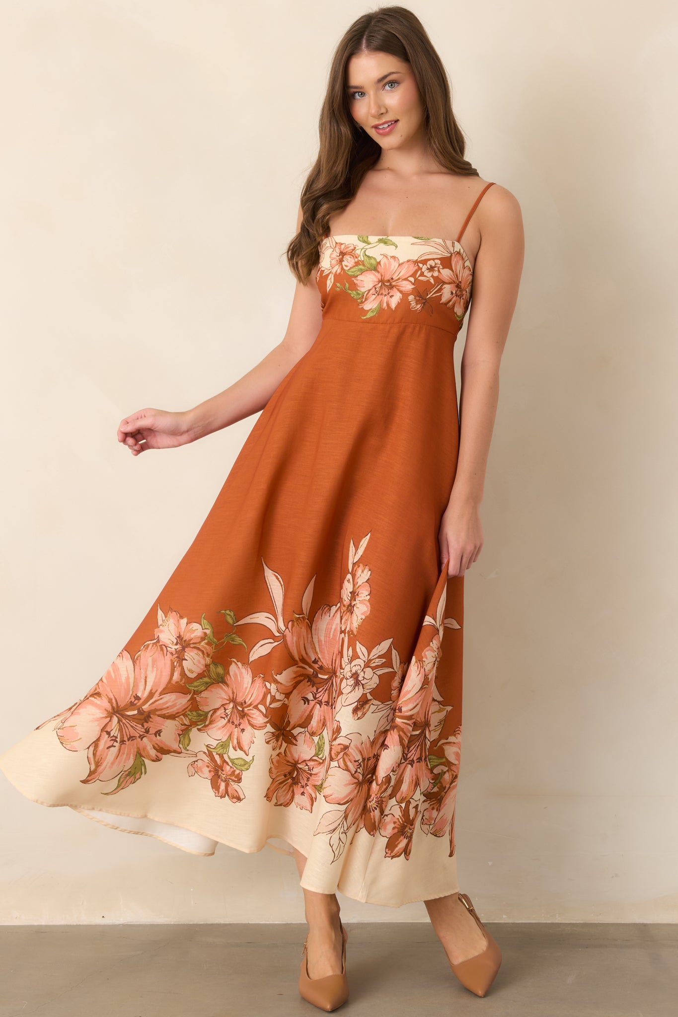 Strappy terracotta dress featuring large-scale botanical borders in ivory, blush, and green for a striking finish.