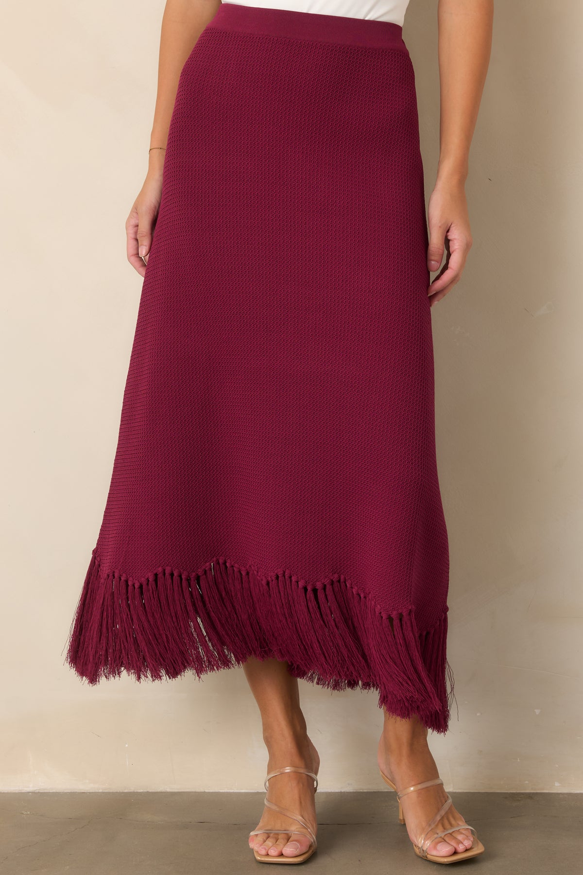 Textured berry skirt showcasing its smooth upper shape and softly widening lower silhouette.
