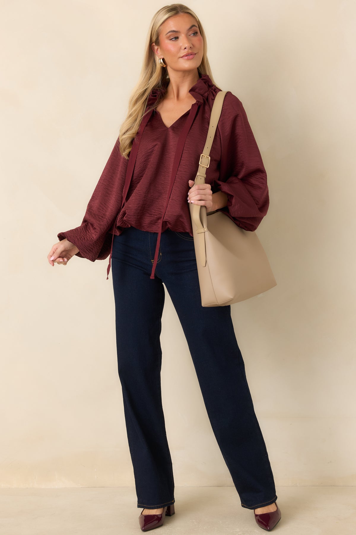 Textured burgundy top with a ruffled collar, relaxed fit, and long ties that accent the neckline.