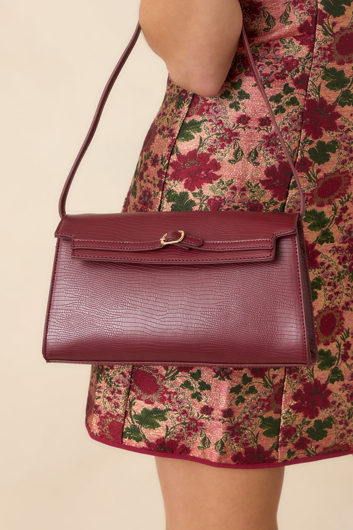 Textured handbag features a sleek envelope flap, delicate gold-tone buckle detail, and an ultra-thin strap for a minimalist silhouette.