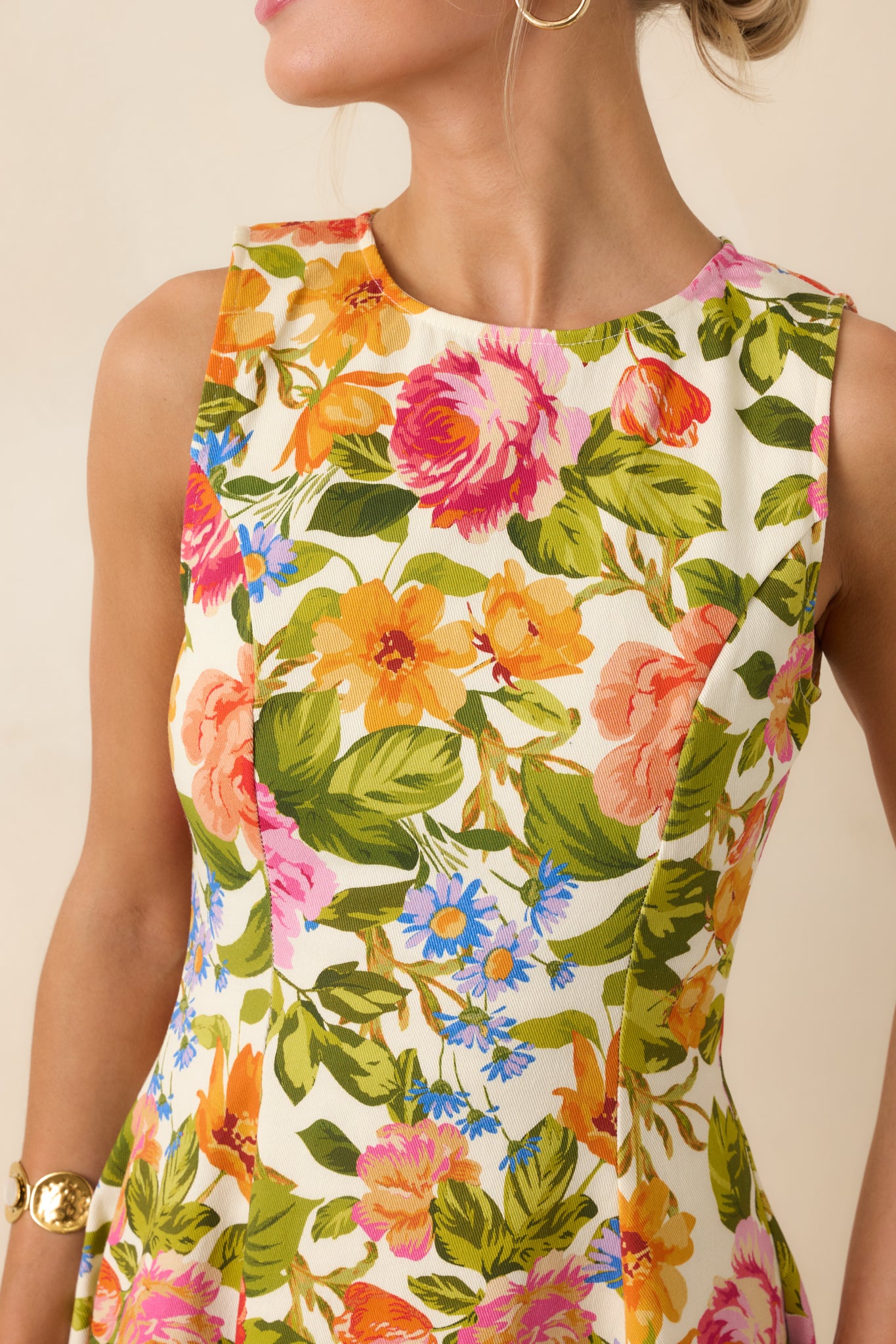 Textured ivory fabric featuring vibrant multicolor floral print with crisp structured stitching.