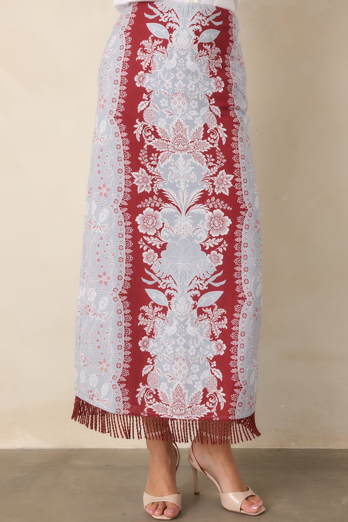 Textured fringe detailing lines the lower hem, bringing subtle movement to the polished cotton-linen skirt.