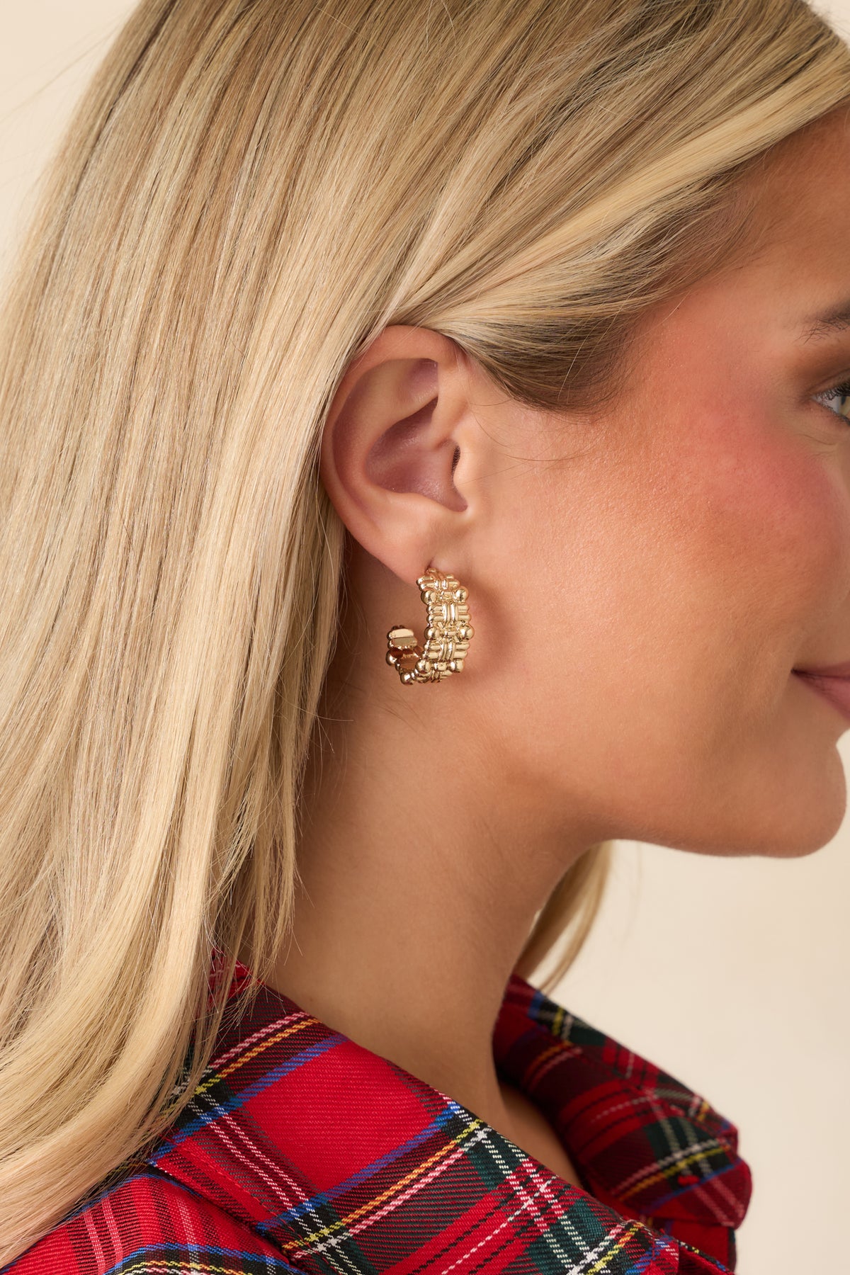Textured gold hoops featuring a rounded shape and subtly wide band.