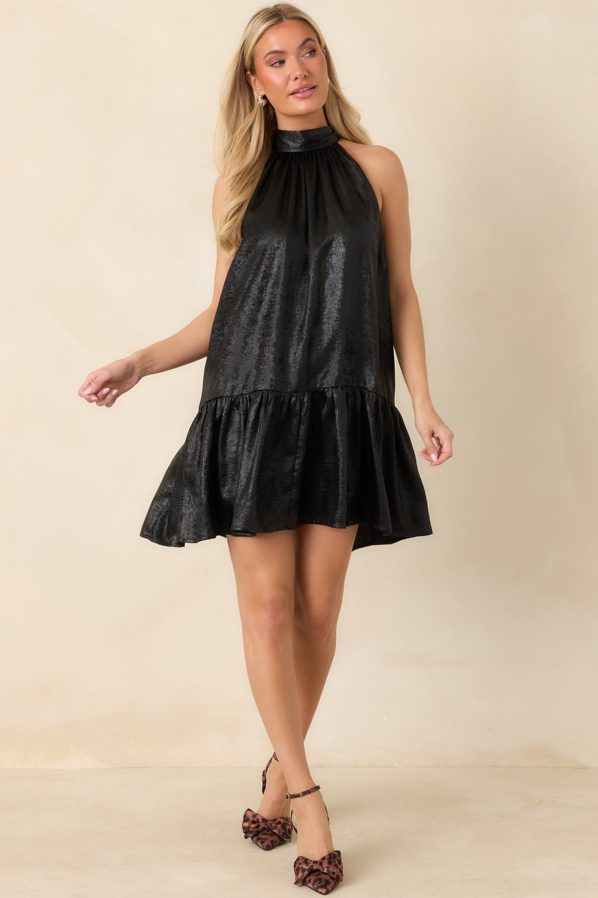 Textured halter mini dress with soft gathers and a flared ruffle-trimmed skirt.