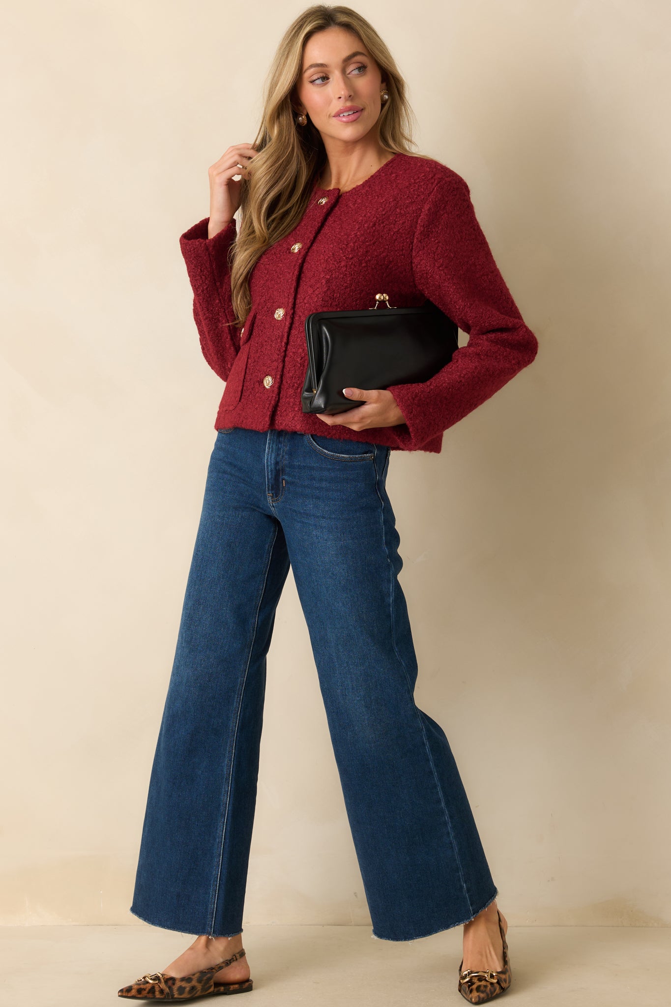 Textured cherry red jacket featuring long sleeves, polished gold buttons, and classic flap pockets at the front.