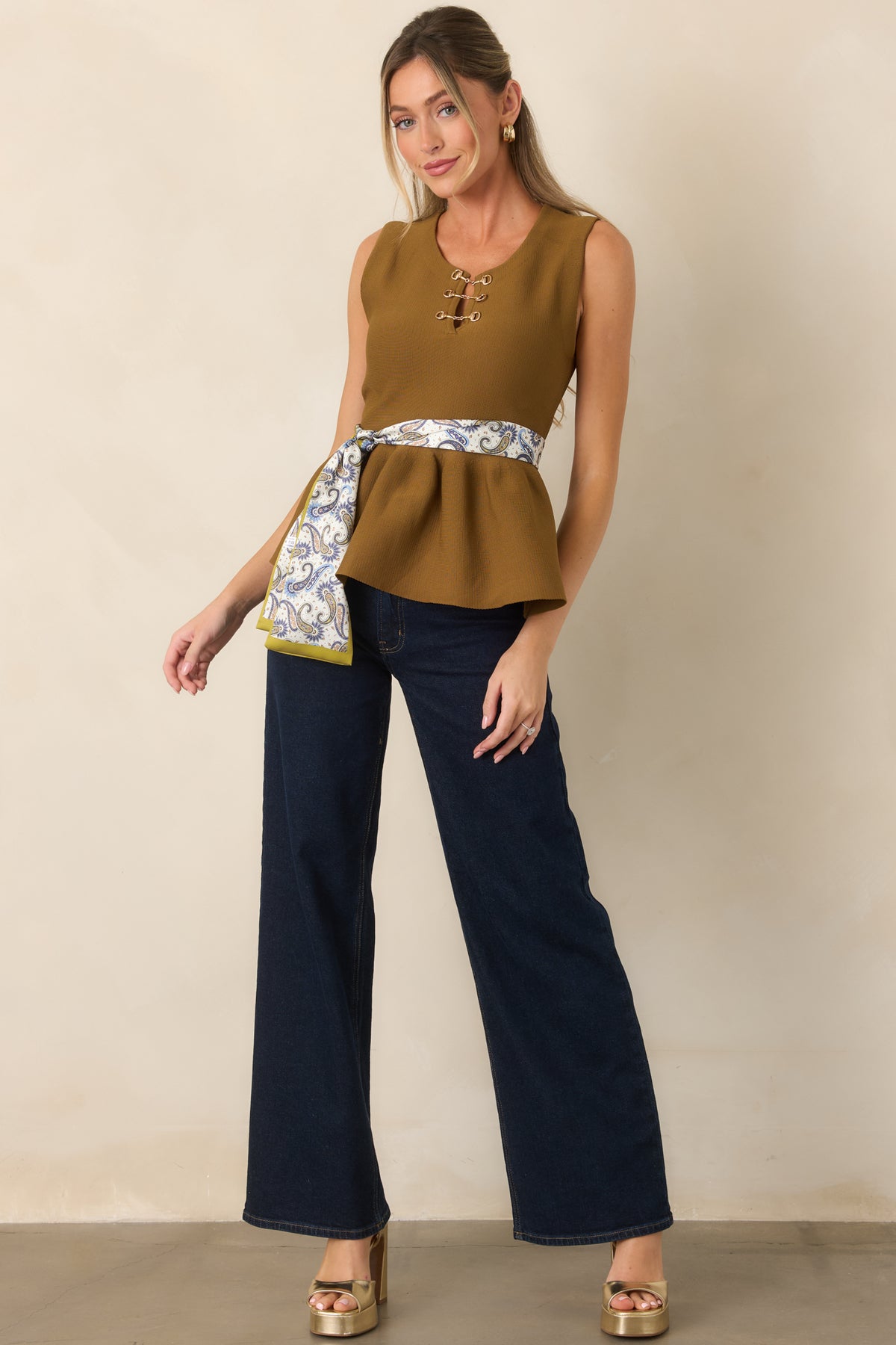 Textured knit top featuring a defined waist and softly flared peplum hem.
