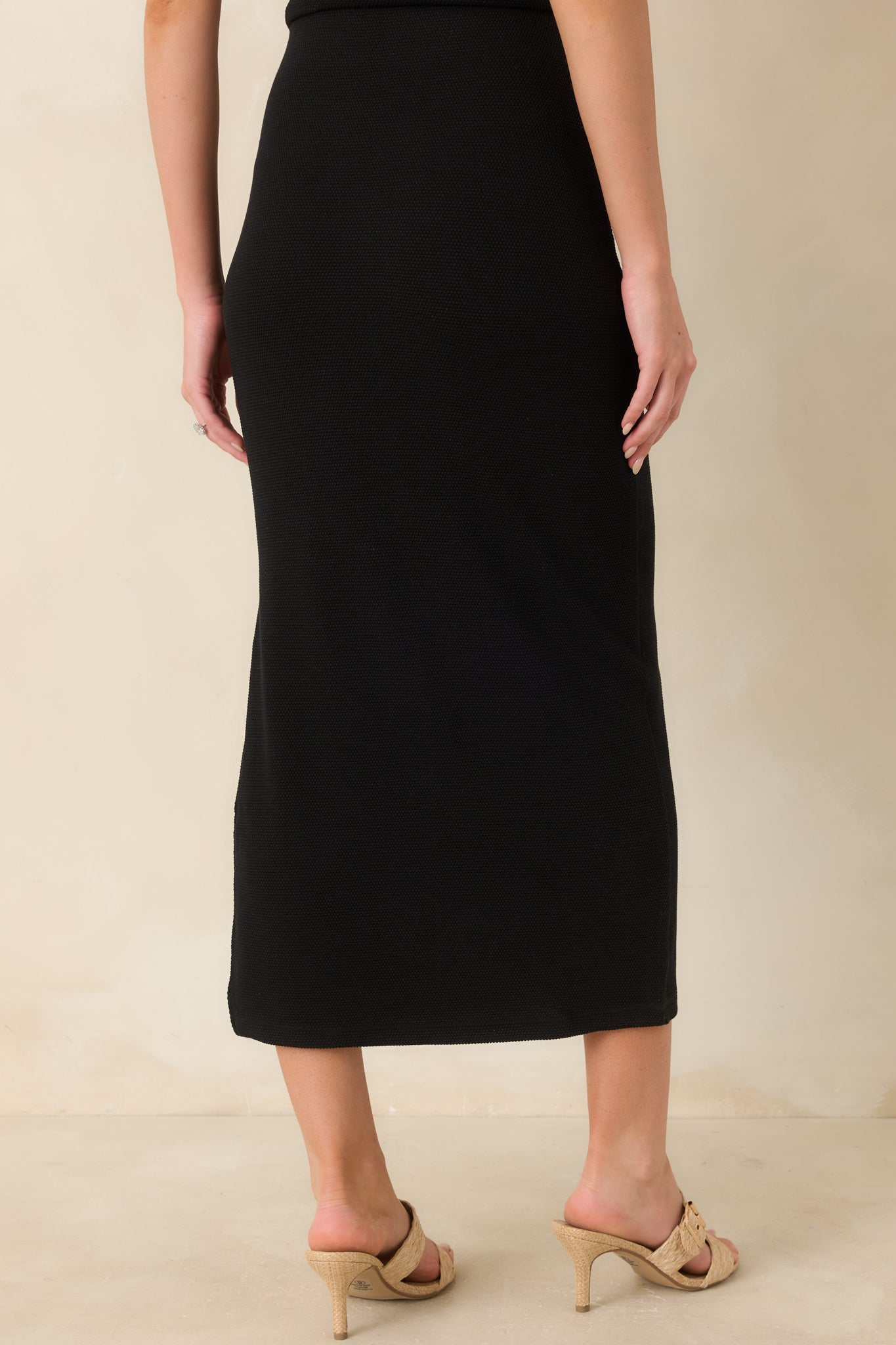 Textured midi skirt with clean rear silhouette and comfortable pull-on fit.

