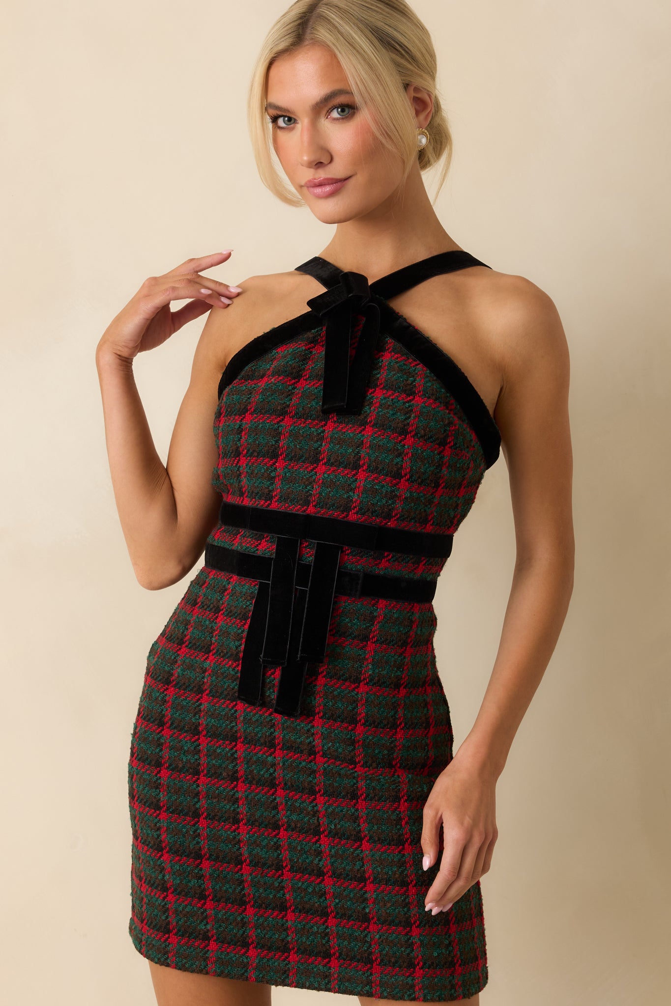 Textured plaid tweed and smooth velvet details meeting at the structured front of the dress.