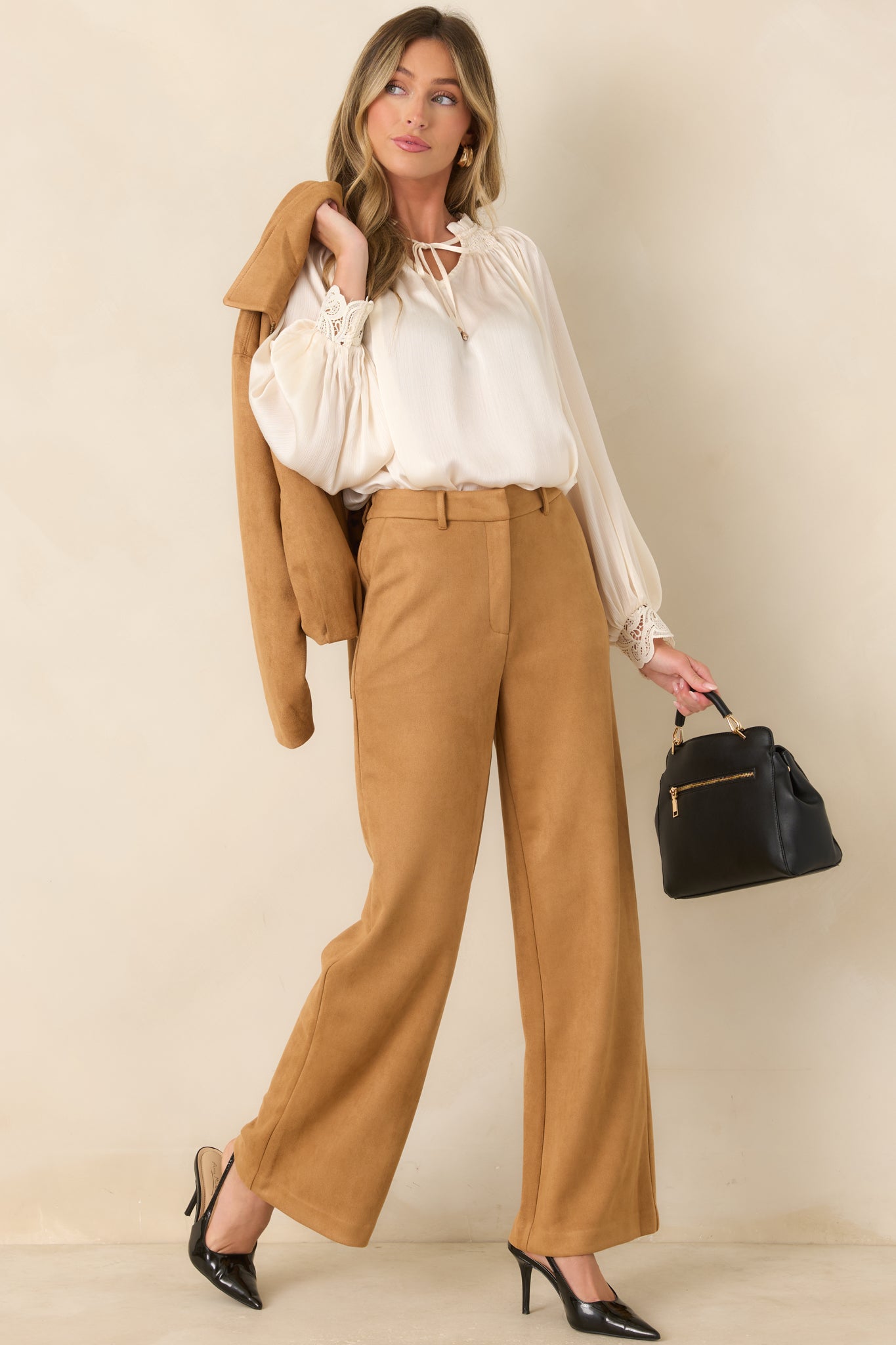 Lightly textured blouse featuring a smocked ruffle neckline, a V-shaped opening with slender tie details, long balloon sleeves, and intricate lace cuffs.