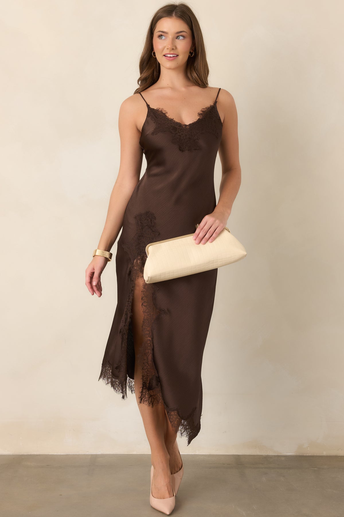 Textured satin dress showcasing a graceful midi length, lace-accented side slit, delicate spaghetti straps, and a softly flowing asymmetrical hem.