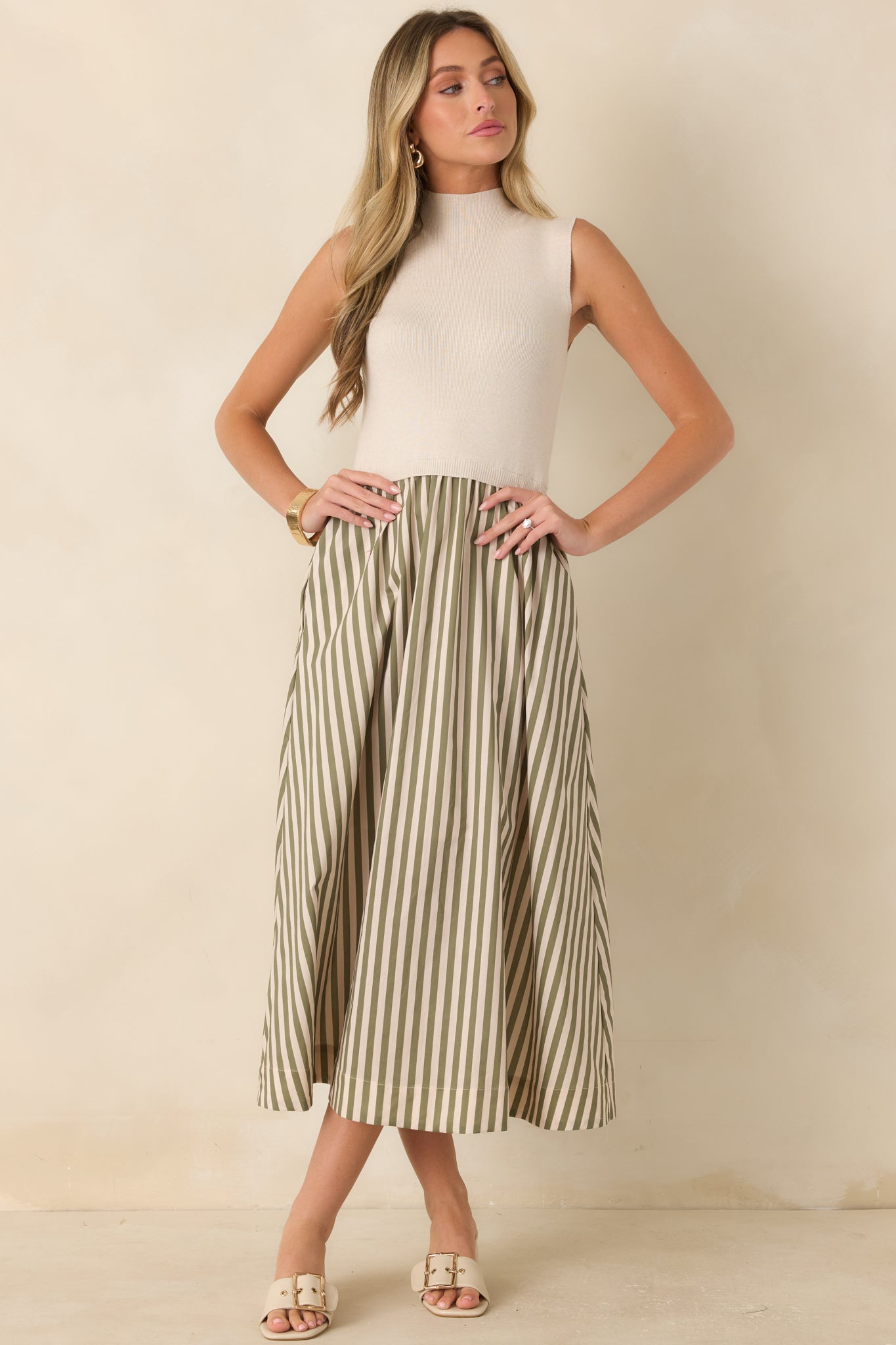 Textured sleeveless midi dress featuring a mock neckline, comfortable fitted bodice, and full skirt with soft striped detailing.