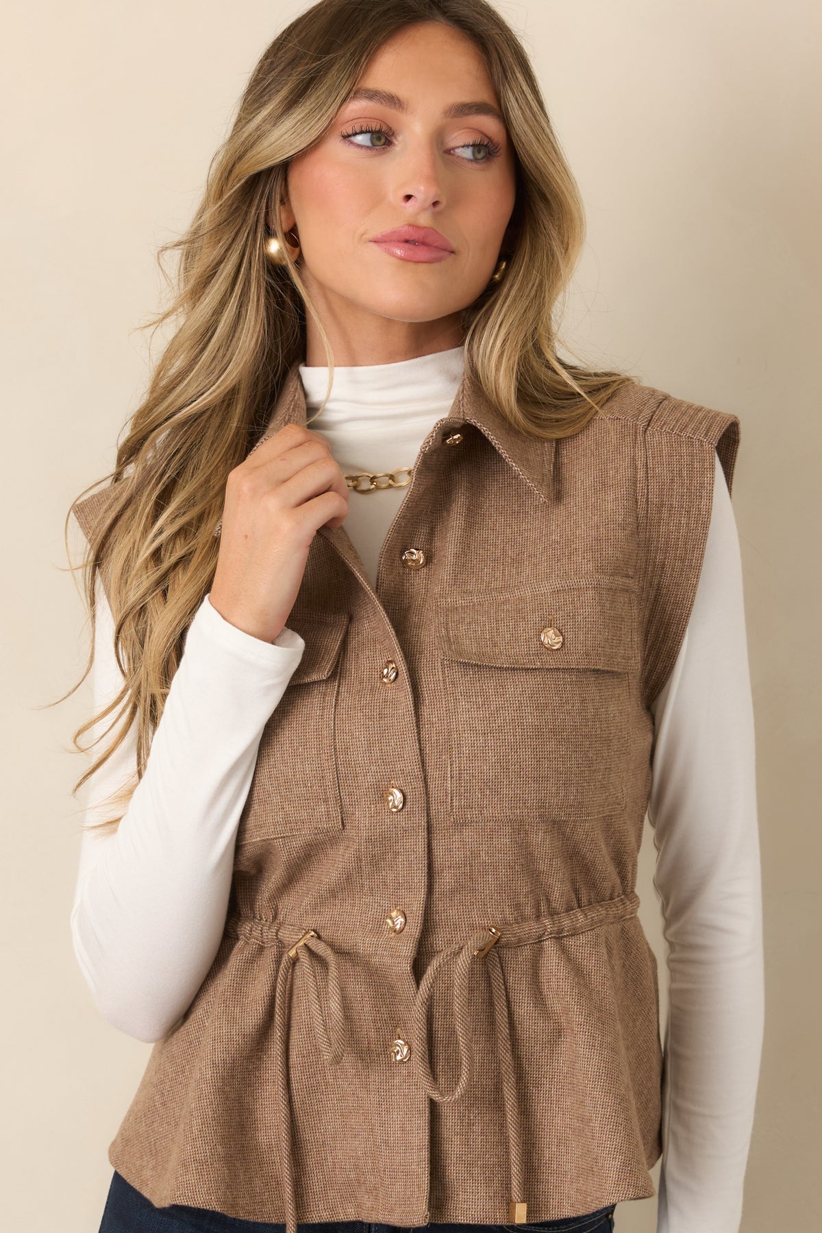 Textured sleeveless vest showcasing the adjustable drawstring waist and wide shoulder construction.