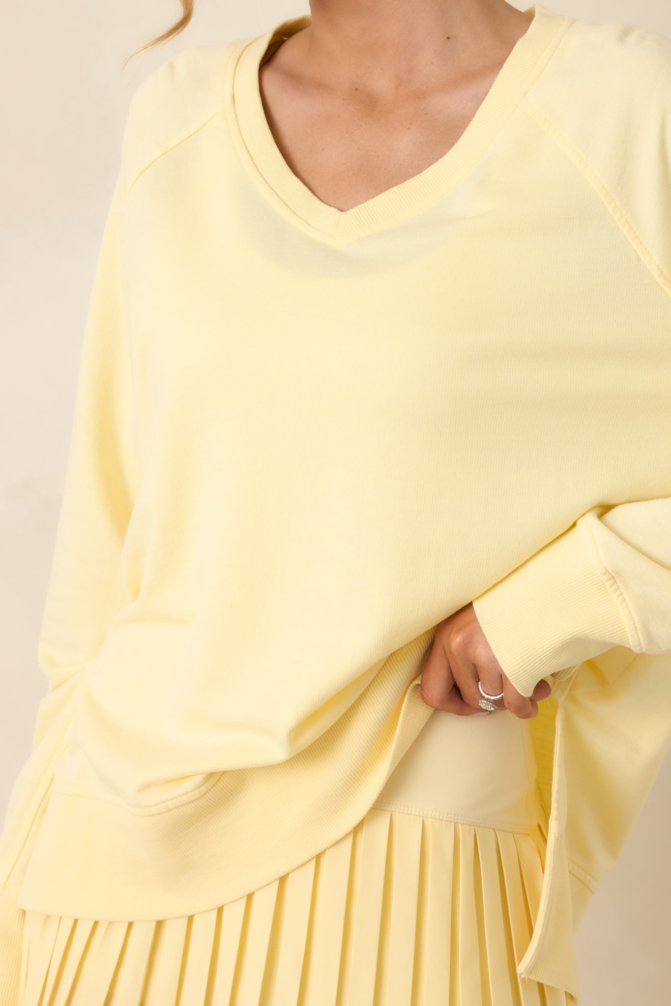 Textured yellow knit fabric with soft stretch and finely ribbed neckline.