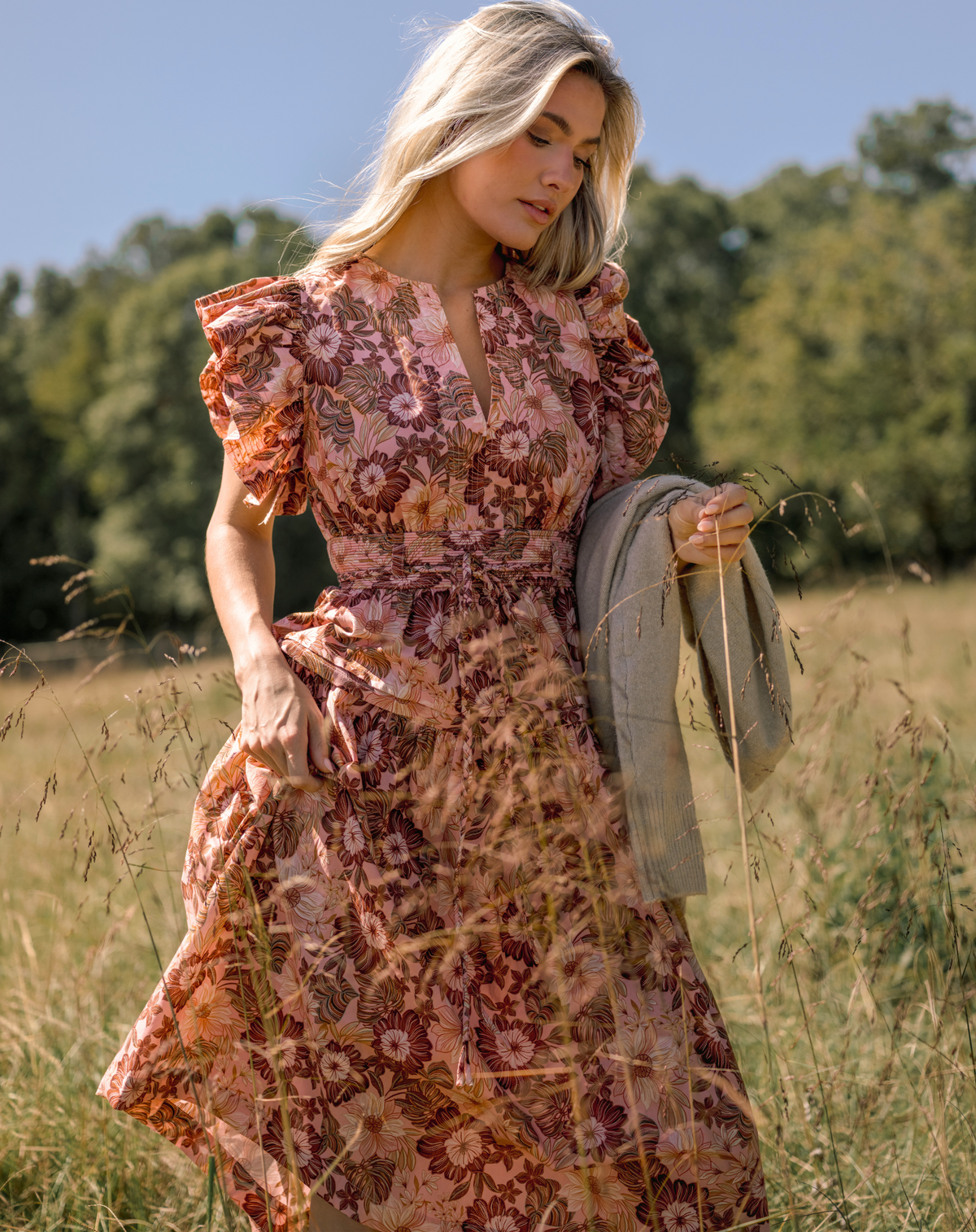 Model wearing a pink floral midi dress.