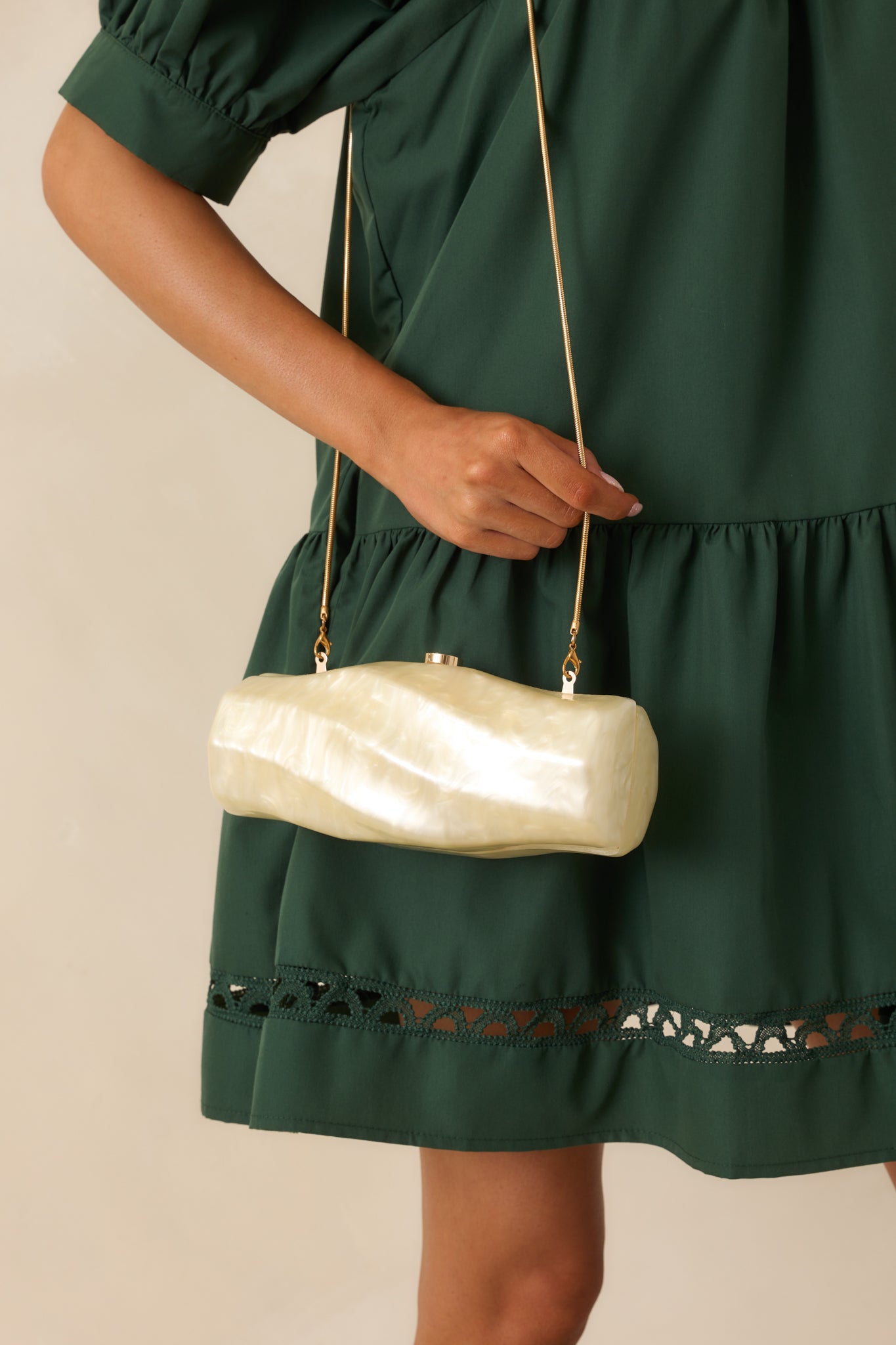 A front-facing view of the clutch featuring its magnetic hinged closure and optional gold snake link chain.