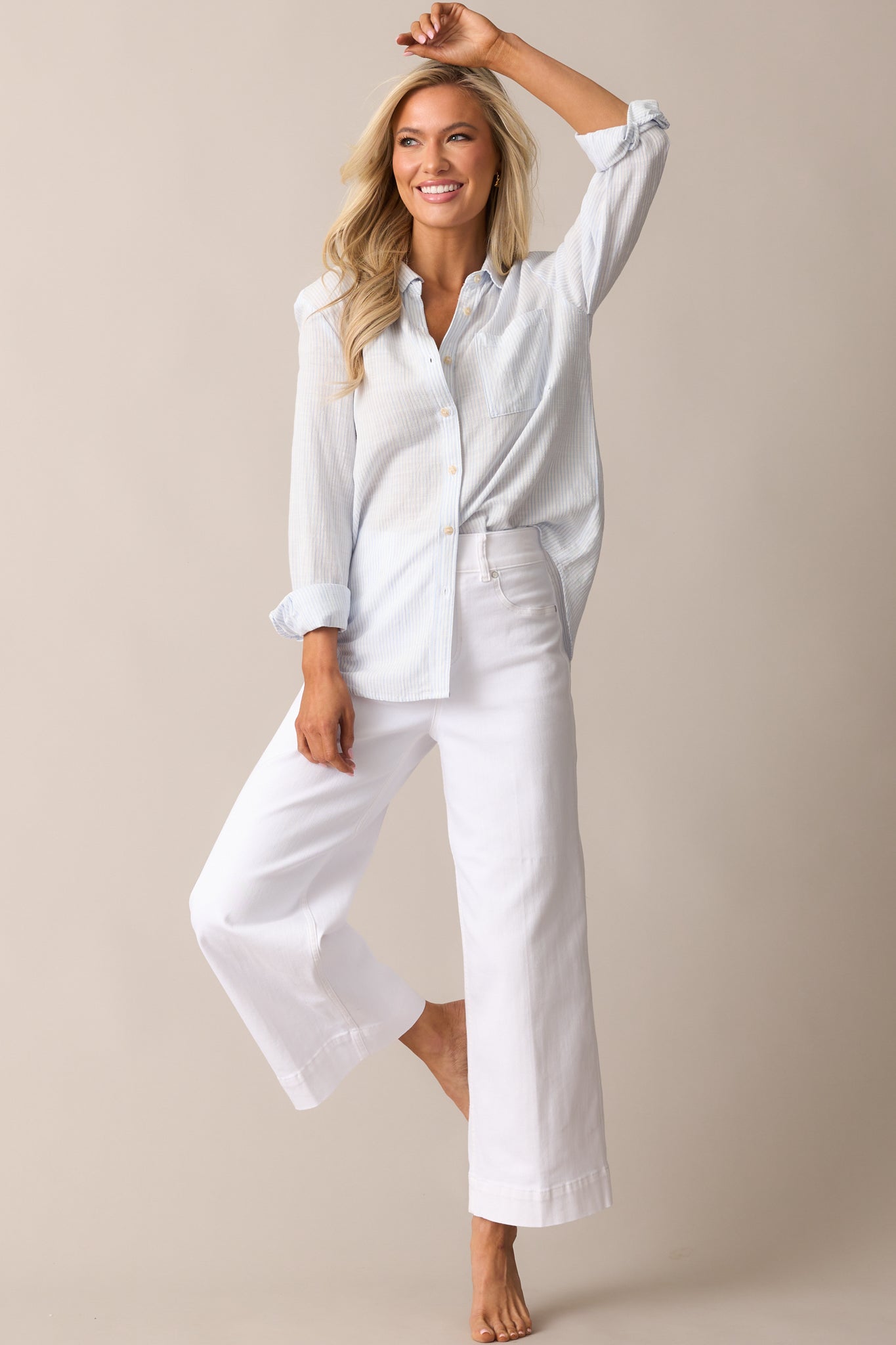 Front full-length view of high-waisted jeans showing the smooth silhouette and faux button front design.