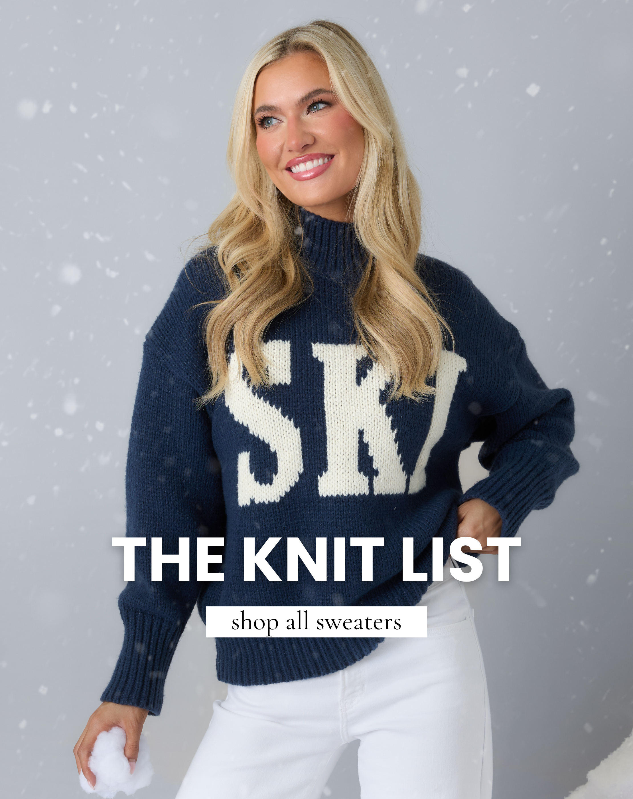 Model wearing a navy knit sweater with bold lettering, styled for winter, promoting the All Sweaters collection.