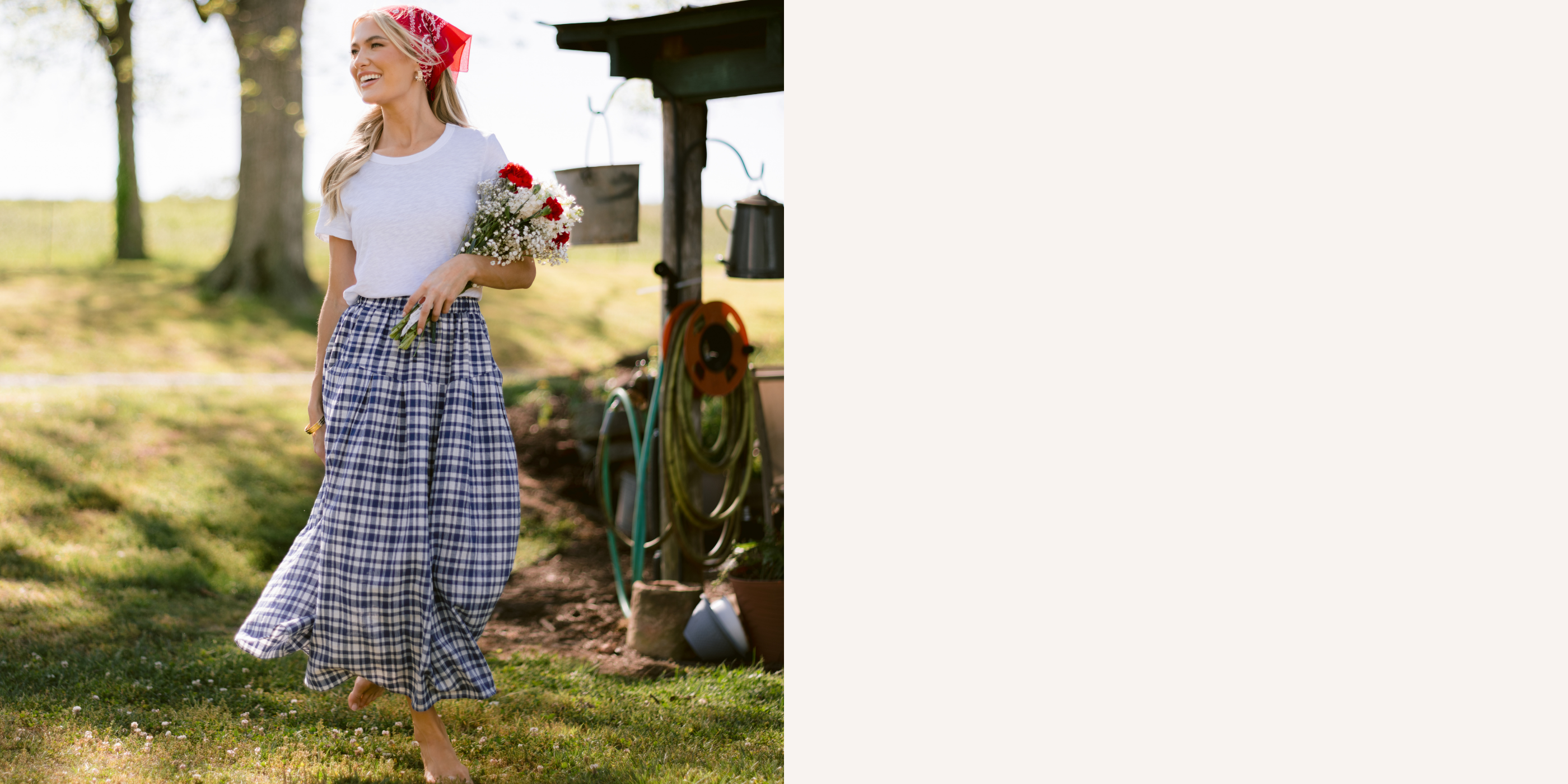 Woman in a checkered skirt and white top standing outdoors with a field and trees in the background.