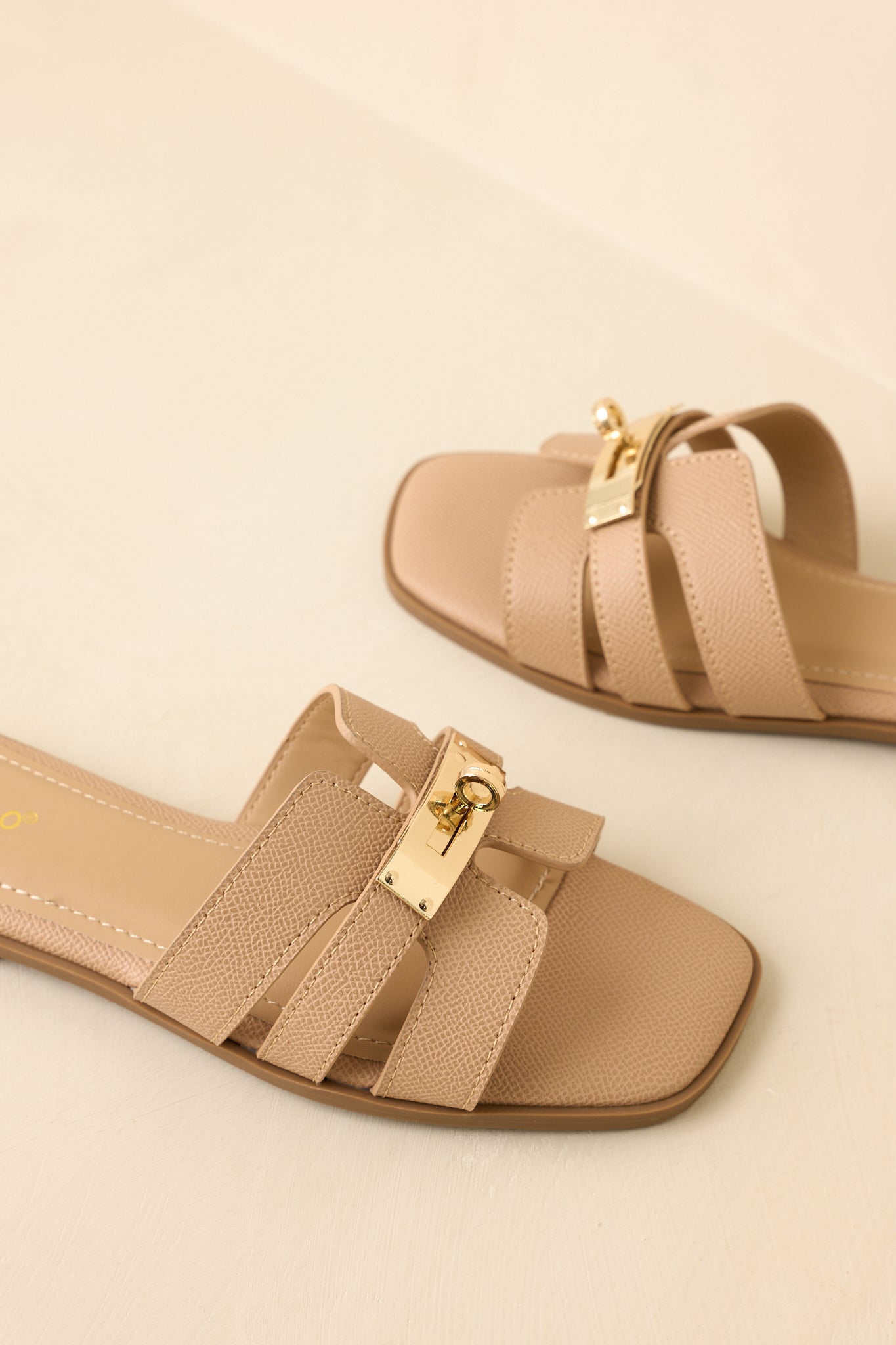 Three-quarter angle showcasing textured straps and polished hardware detail.