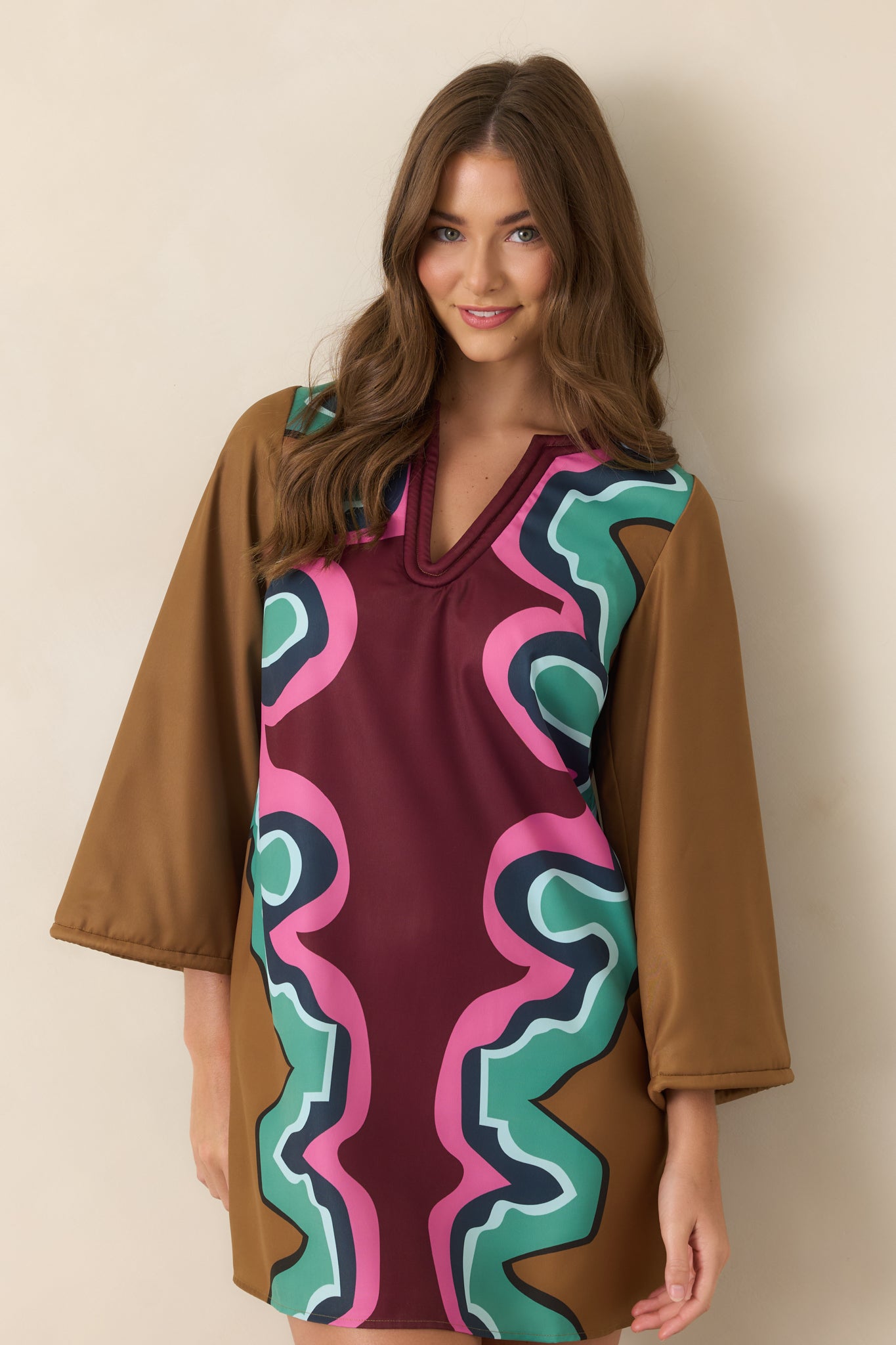 Mini dress detail featuring a wide three-quarter sleeve finished with polished matching corded trim and a softly lustrous finish.