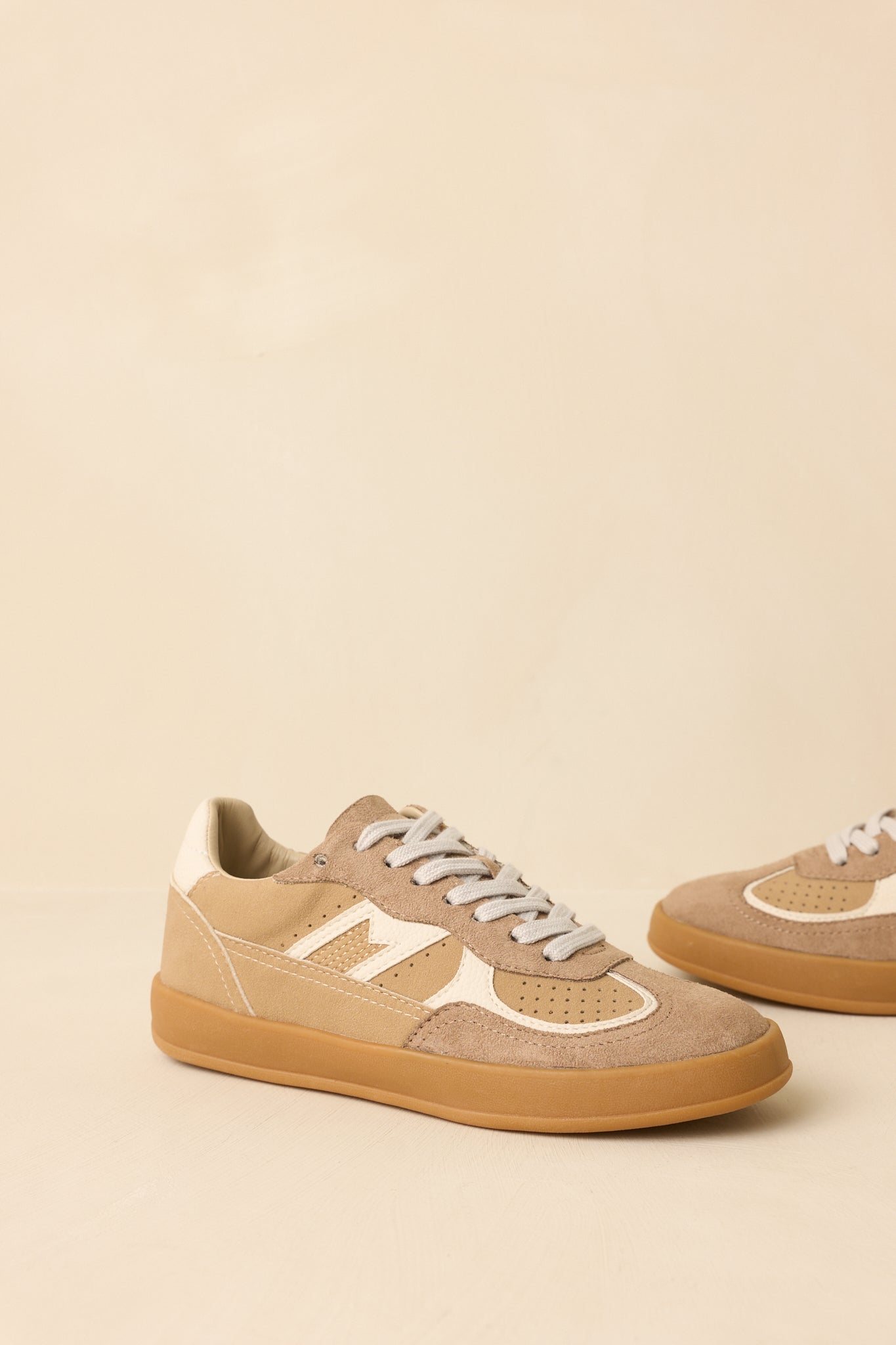 Three-quarter angle highlighting the lace-up design, smooth faux leather panels, and textured suede accents.