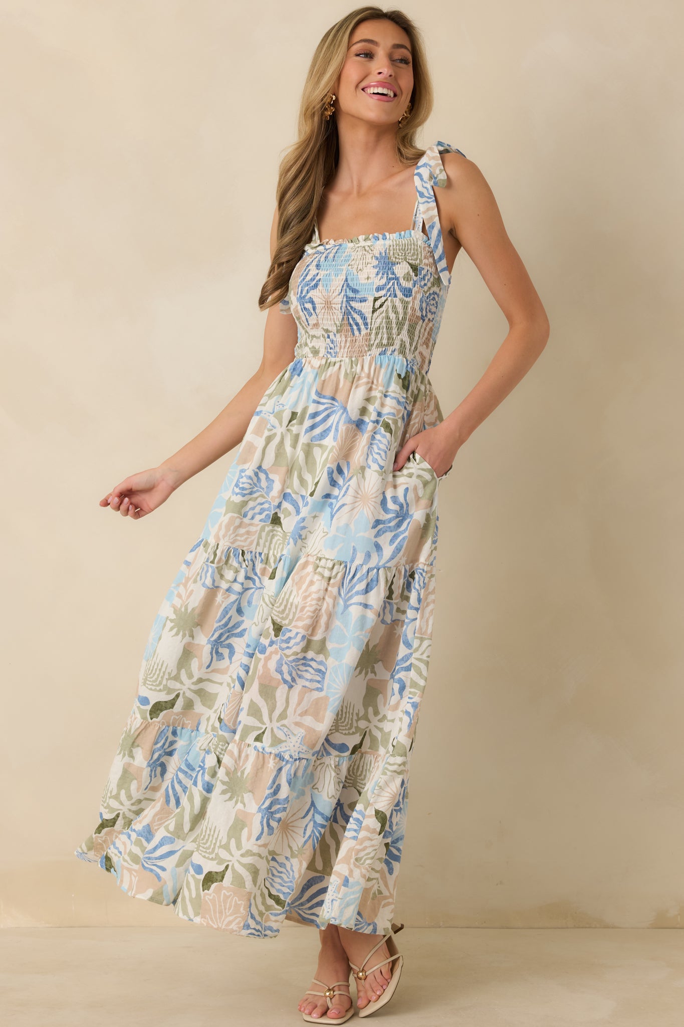 Tiered blue maxi dress featuring lightweight woven fabric and a flexible, flattering smocked bodice.
