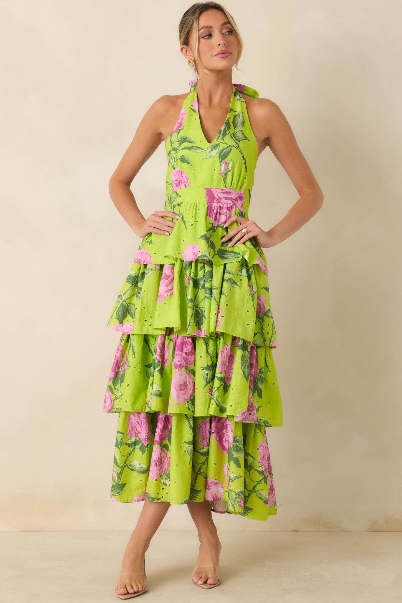 Tiered cotton midi dress highlighting intricate eyelet texture, halter styling, and a voluminous skirt.