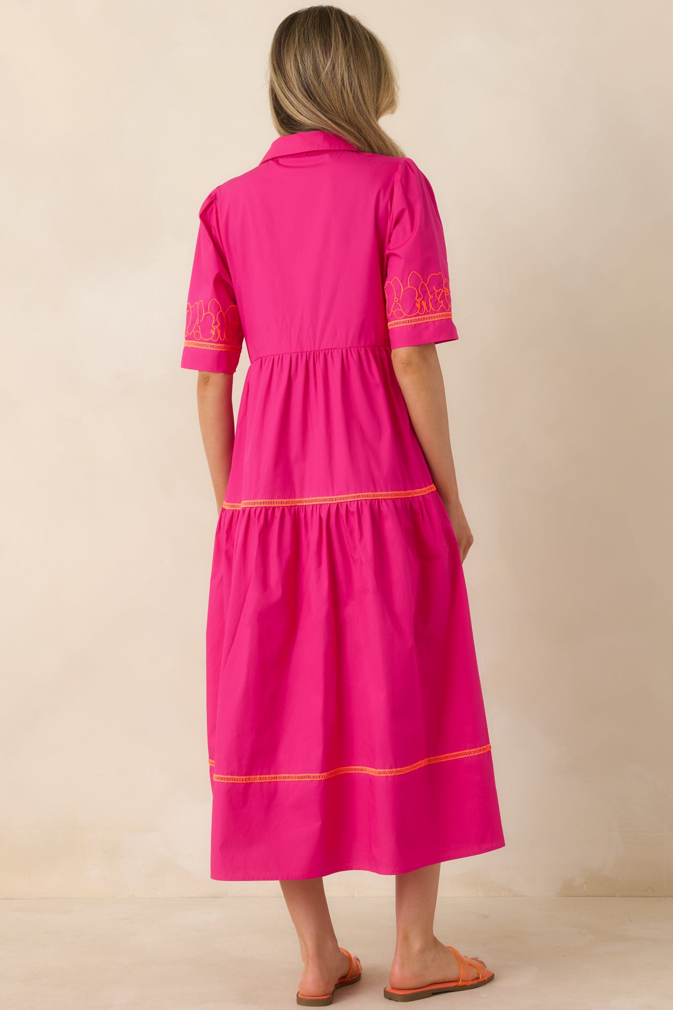 Tiered dress with flowing silhouette and smooth rear finish.
