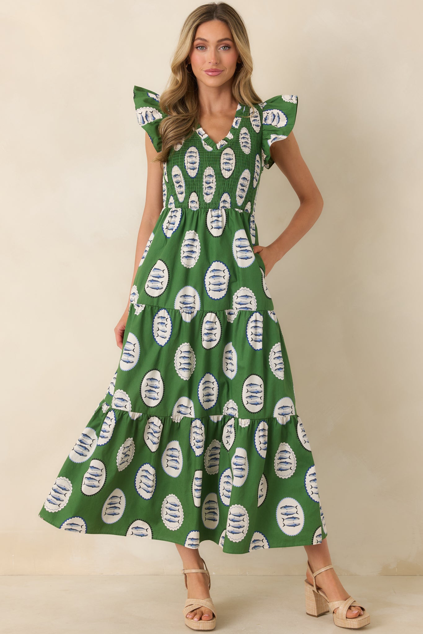 Tiered green maxi dress with allover fish print, flexible smocked bodice, and relaxed, airy shape