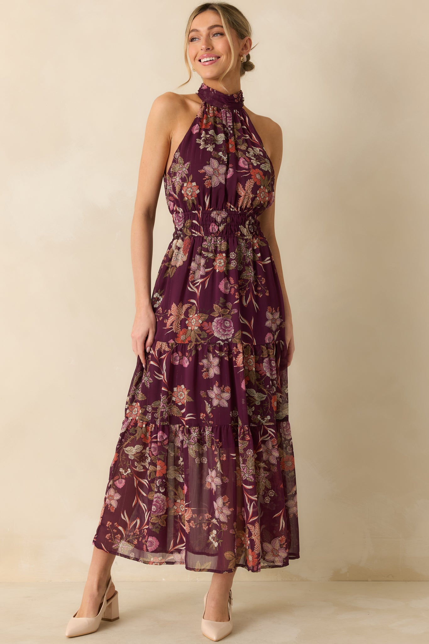 The tiered maxi skirt emphasizes movement and the full lining beneath the semi-sheer floral fabric.