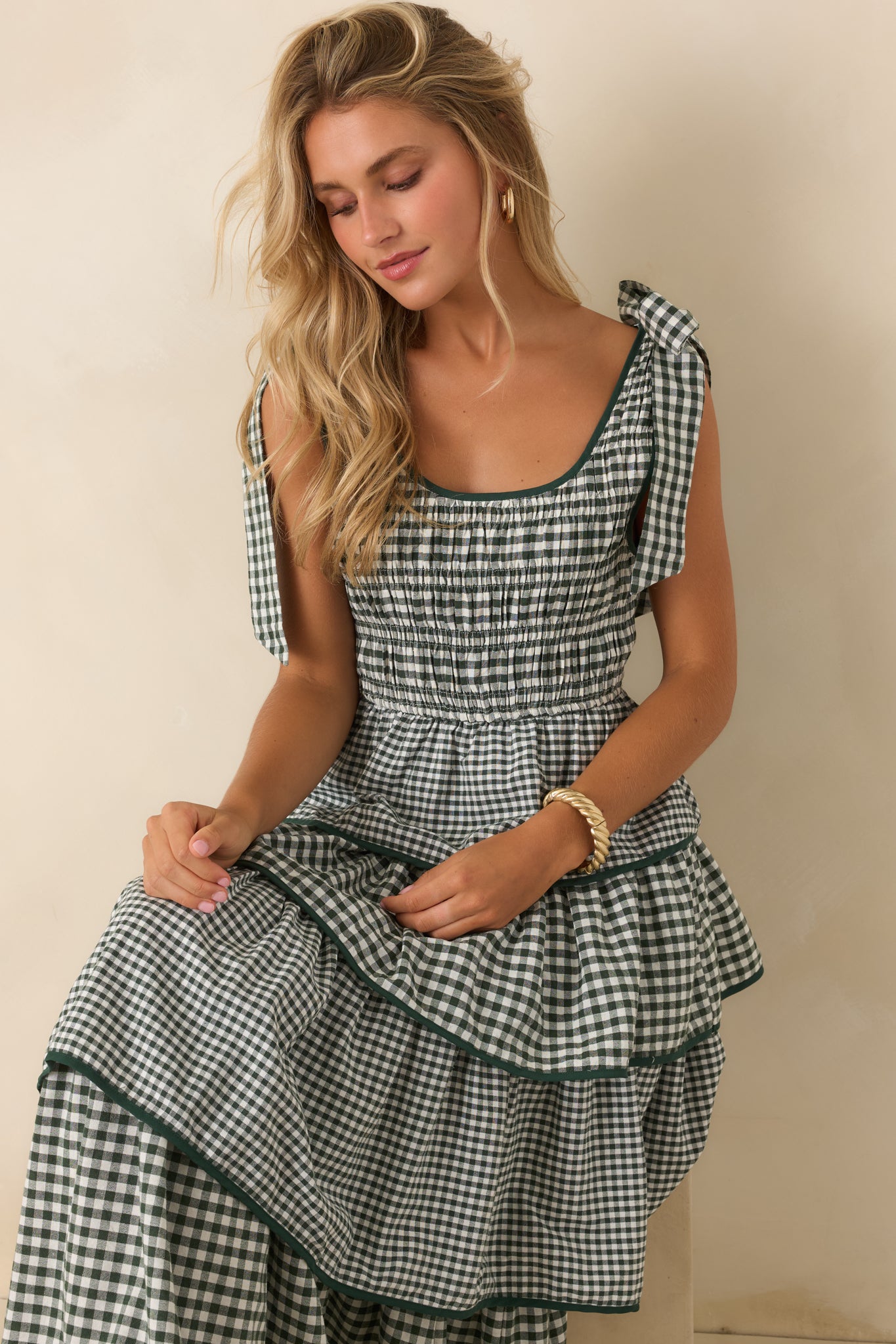 Flowing tiered dress designed with a comfortable smocked bodice, defined waist, and playful shoulder ties.