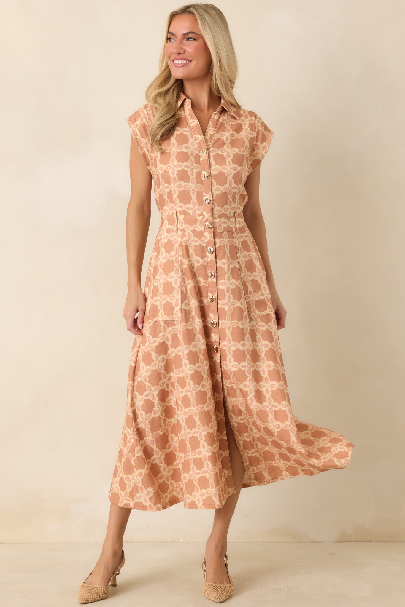 Timeless collared midi dress designed with gold-tone button closures, side pockets, and a comfortable elastic waist.