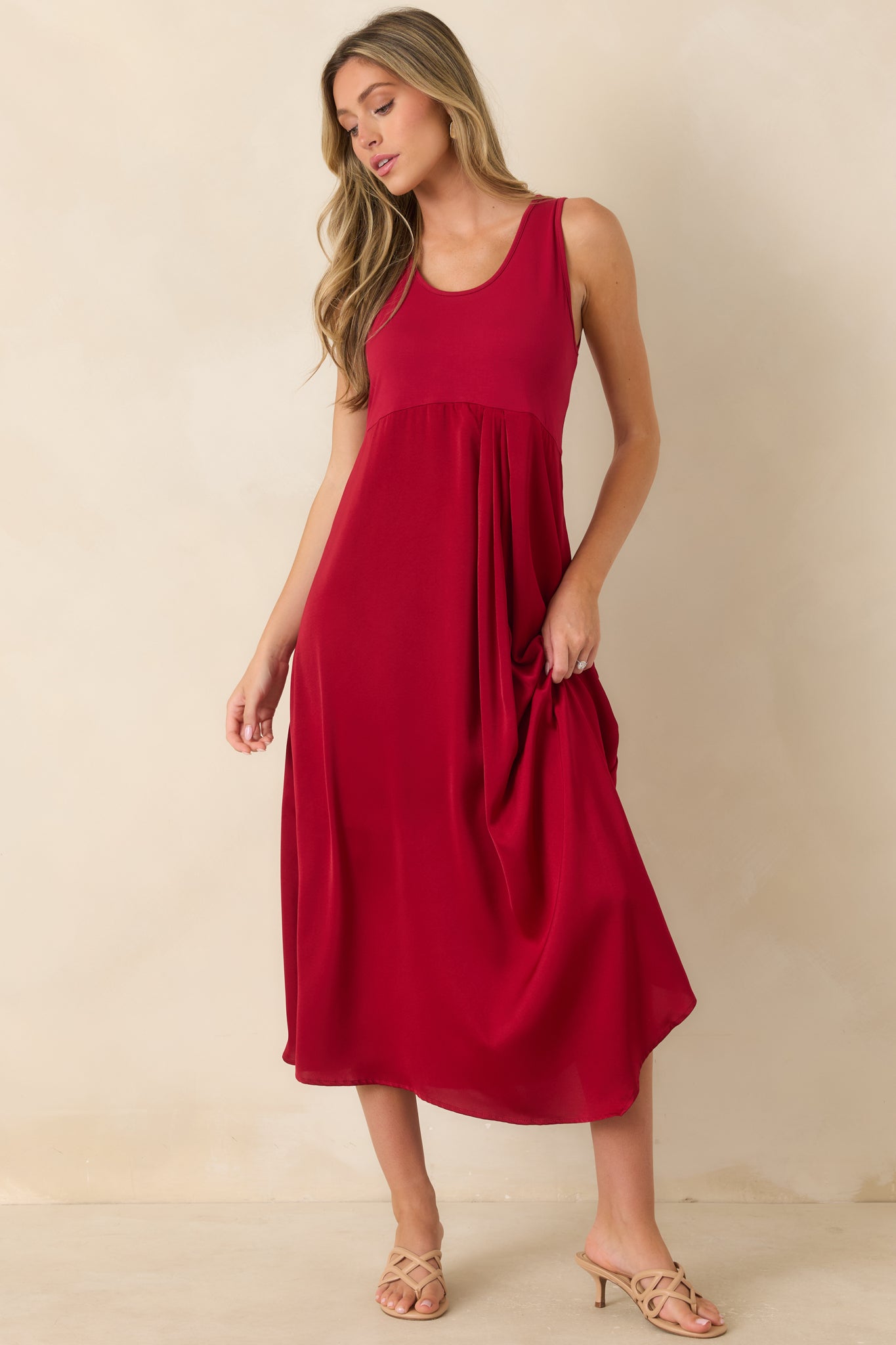Timeless midi dress featuring a structured knit bodice and a satin skirt with a polished, elevated finish.