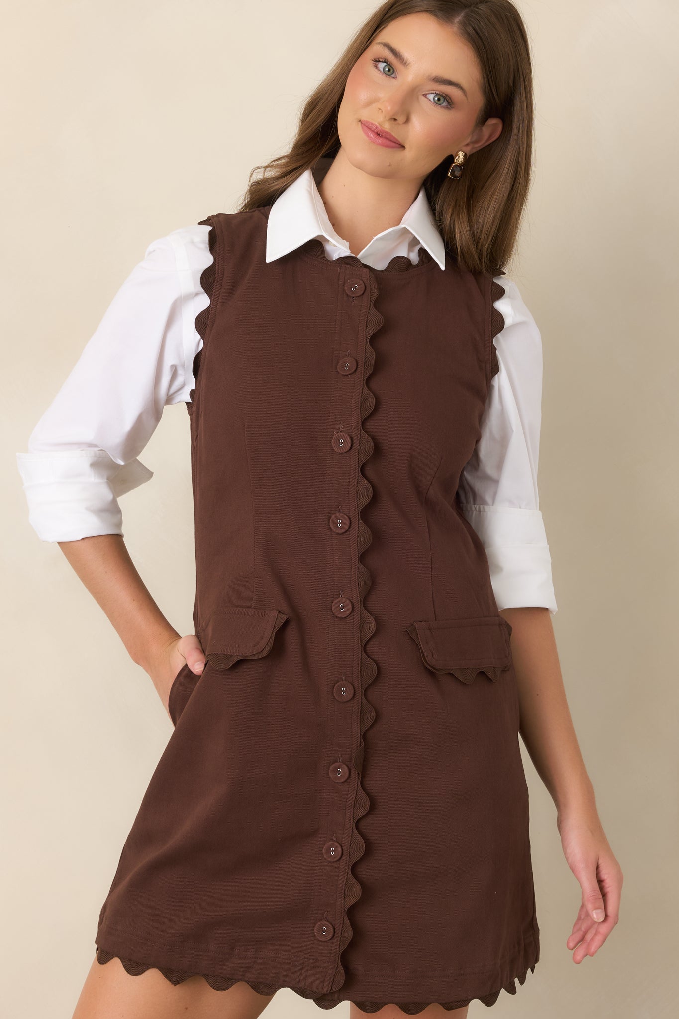 Tonal ric rac trim outlines the neckline and armholes, accenting the sleeveless silhouette and vintage-inspired design.