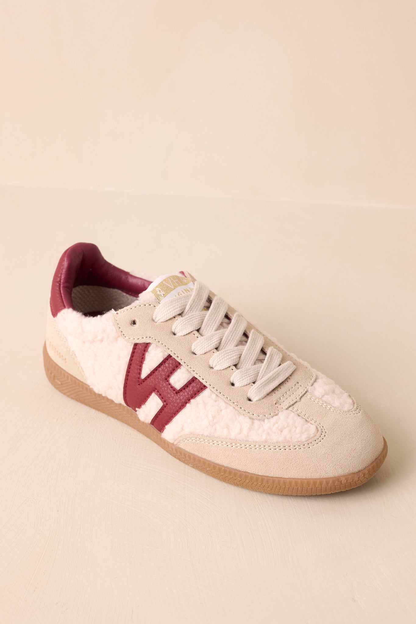 Top-down perspective showing rounded toe, lace-up front, and combination of soft sherpa and suede materials.