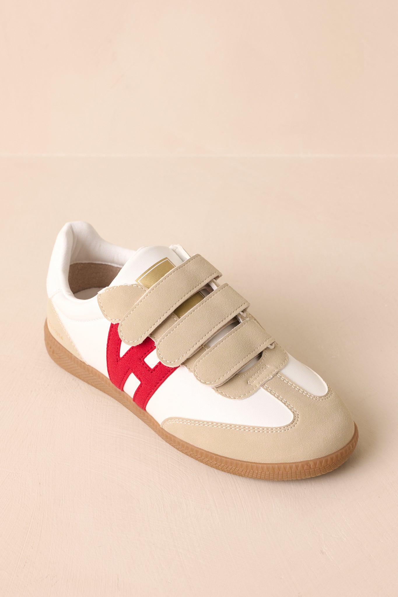 Top-down angle showing the three Velcro closures, ivory upper, and beige suede overlays.