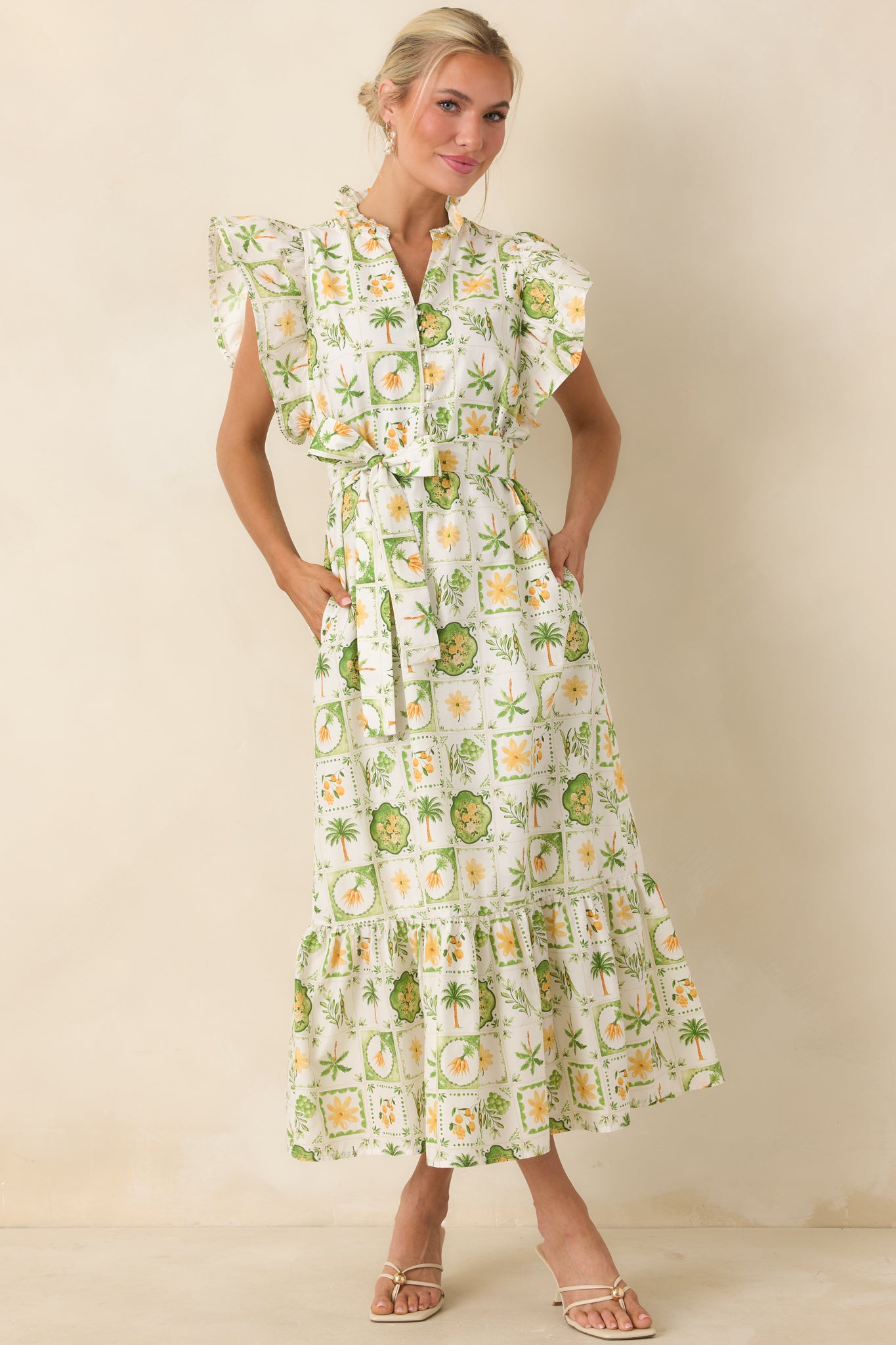 Tropical maxi dress with playful print, flutter sleeves, and flowing tiered silhouette.