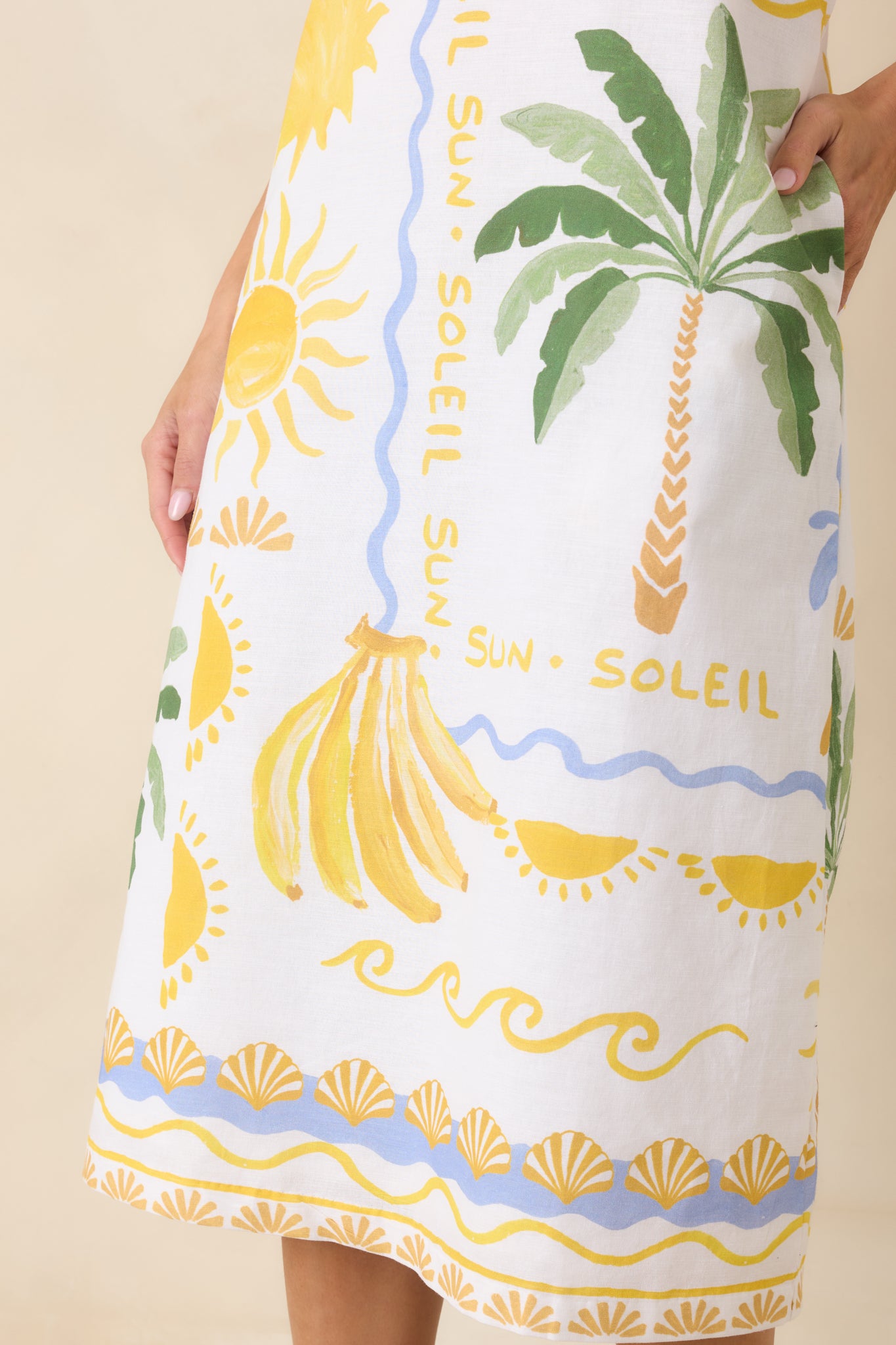 Tight focus on the tropical print and fabric texture, highlighting the colorful patterning and soft linen-blend construction.


