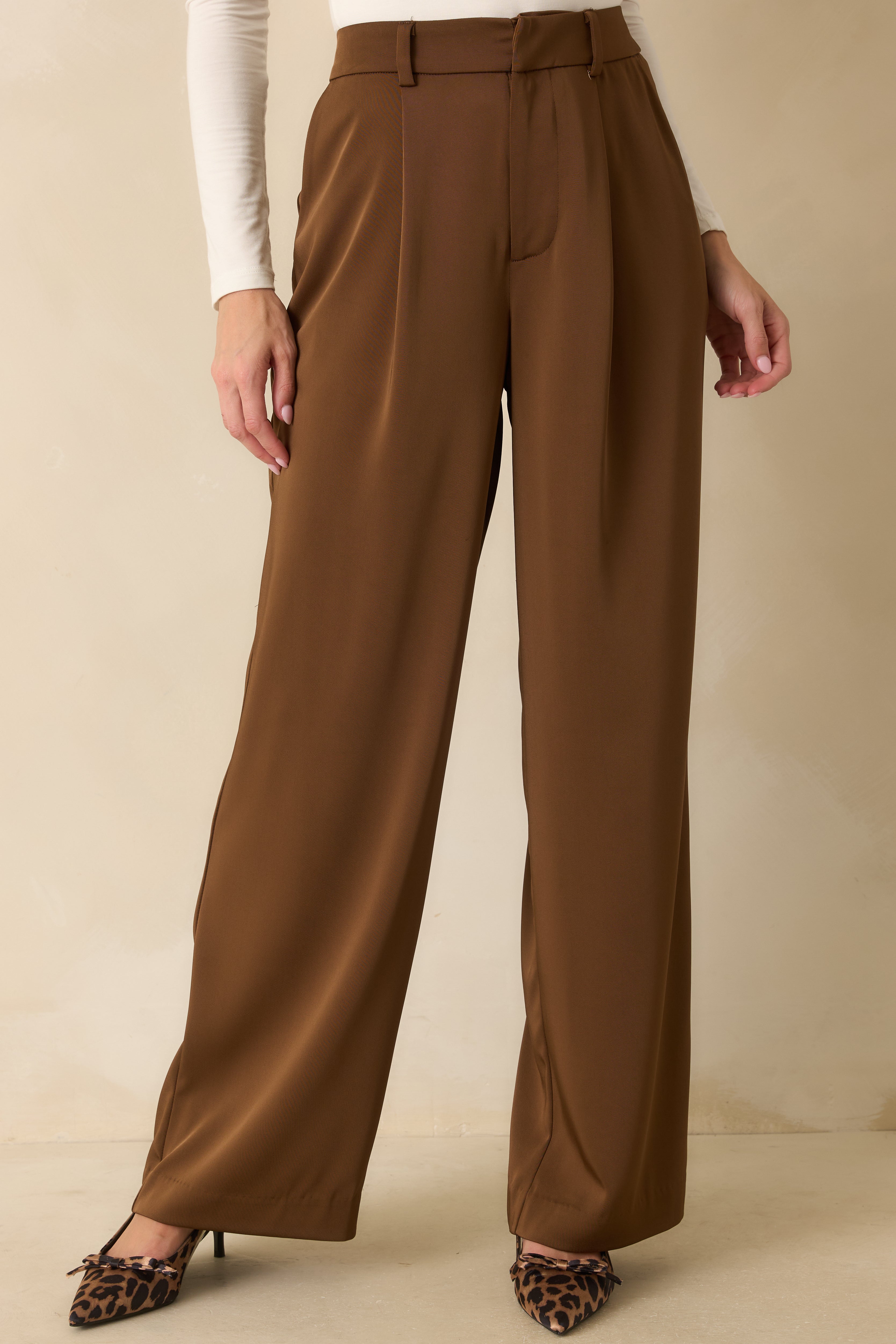 Cropped lower view showing the smooth wide-leg drape and hem detail of the trousers.