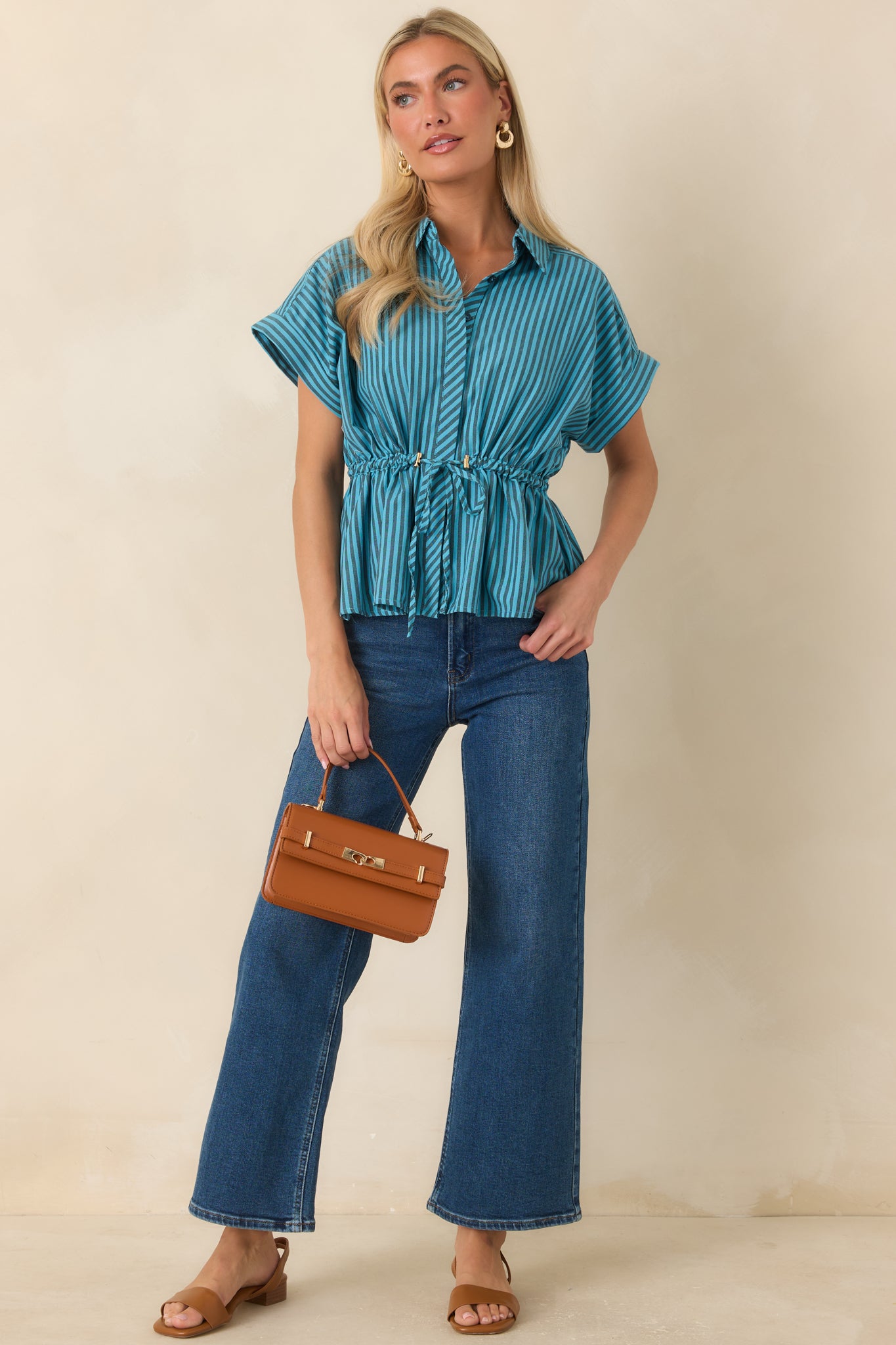 Turquoise striped top showcasing a relaxed silhouette, gathered back yoke, and feminine shape.
