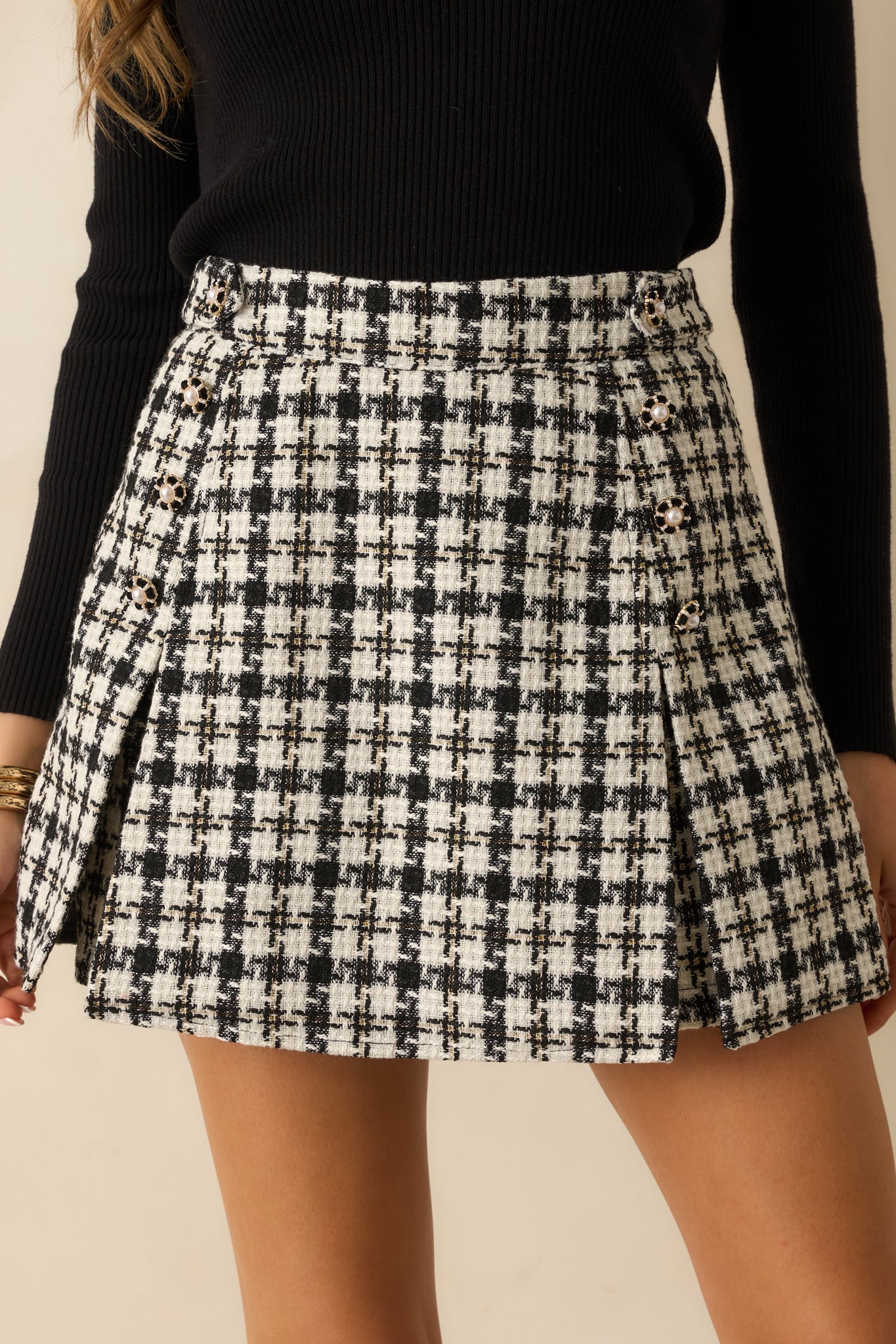 Close view of the skort’s wrap-front design and pleated side panels.