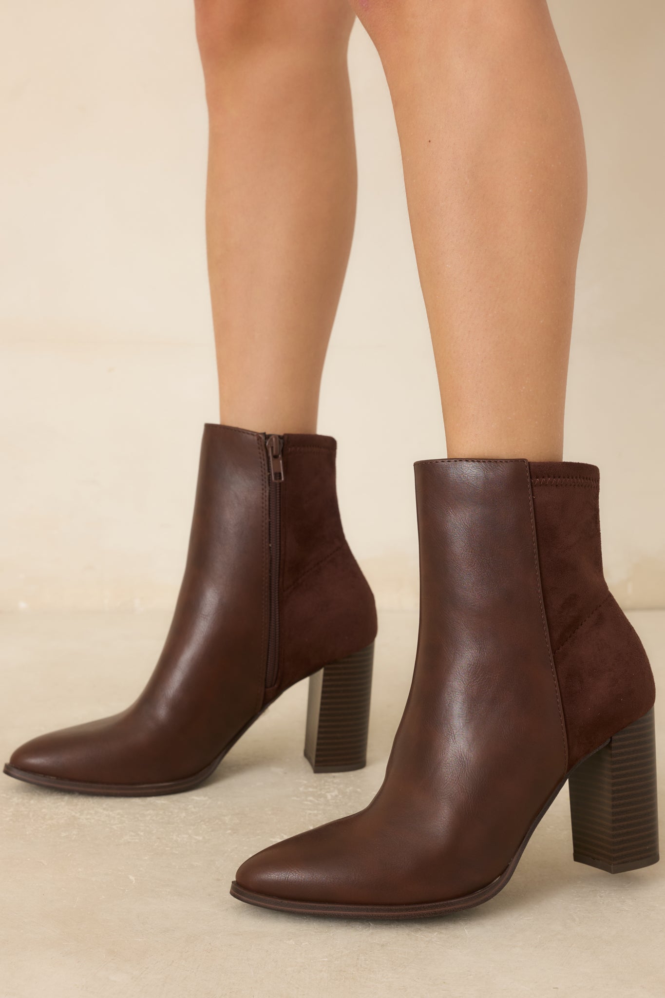 Two-tone ankle boots with a tonal faux suede back panel, inner side zipper closure, and a sleek silhouette.