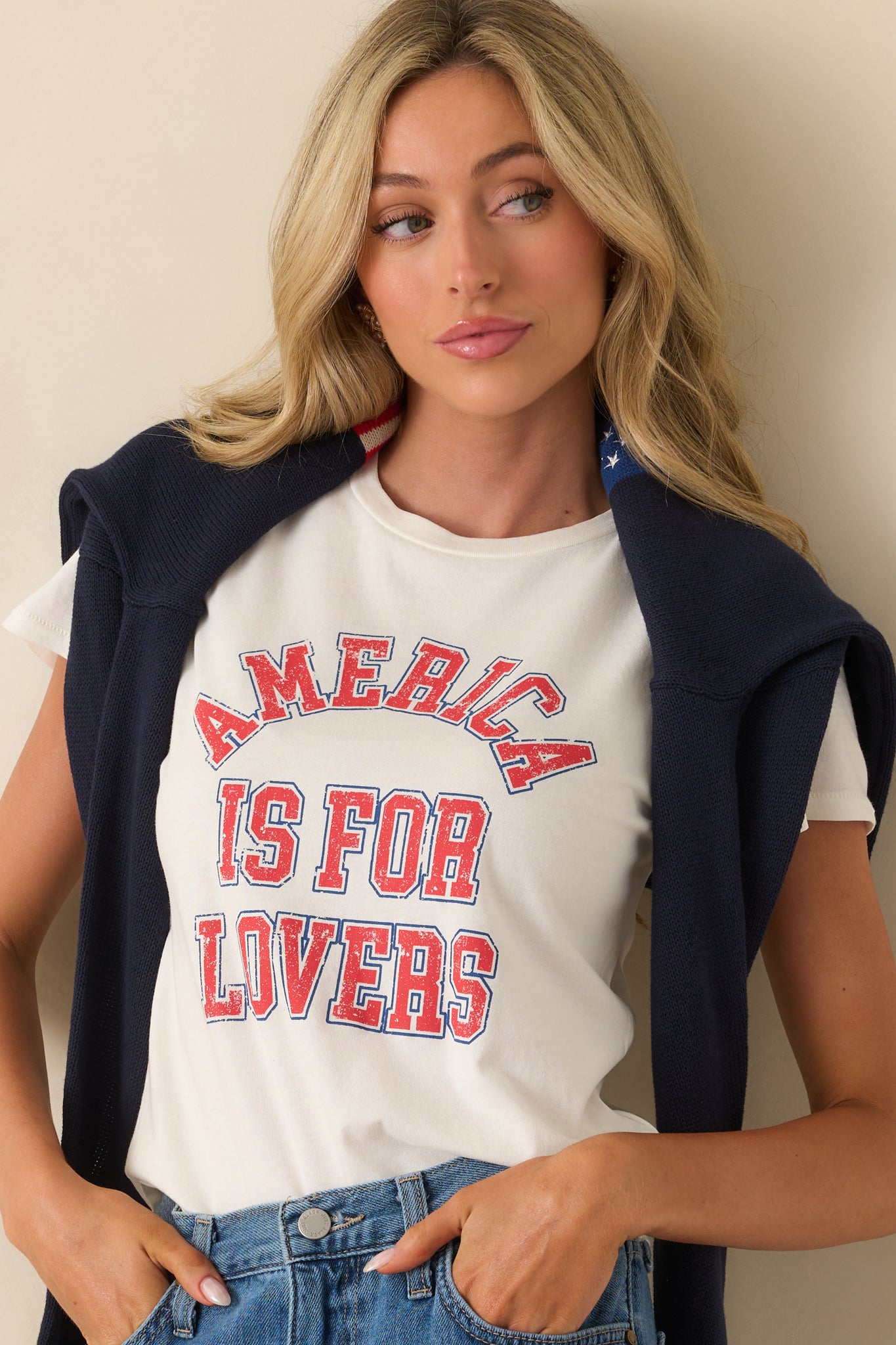 Upper cropped view focusing on the bold red and blue graphic across the chest and the ribbed crew neckline.