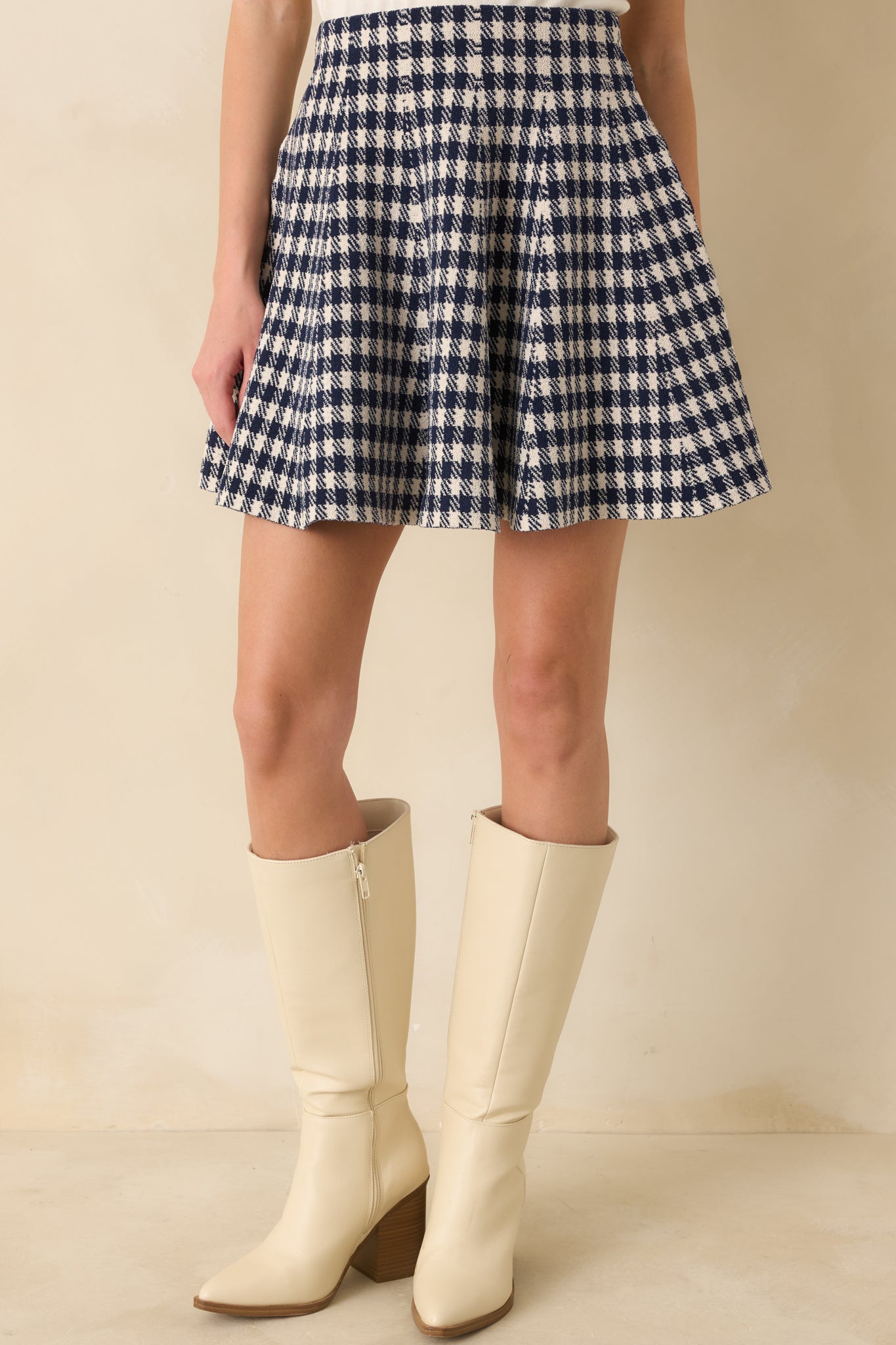 Upper skirt crop highlighting waistband, flared hem, and smooth textured knit.