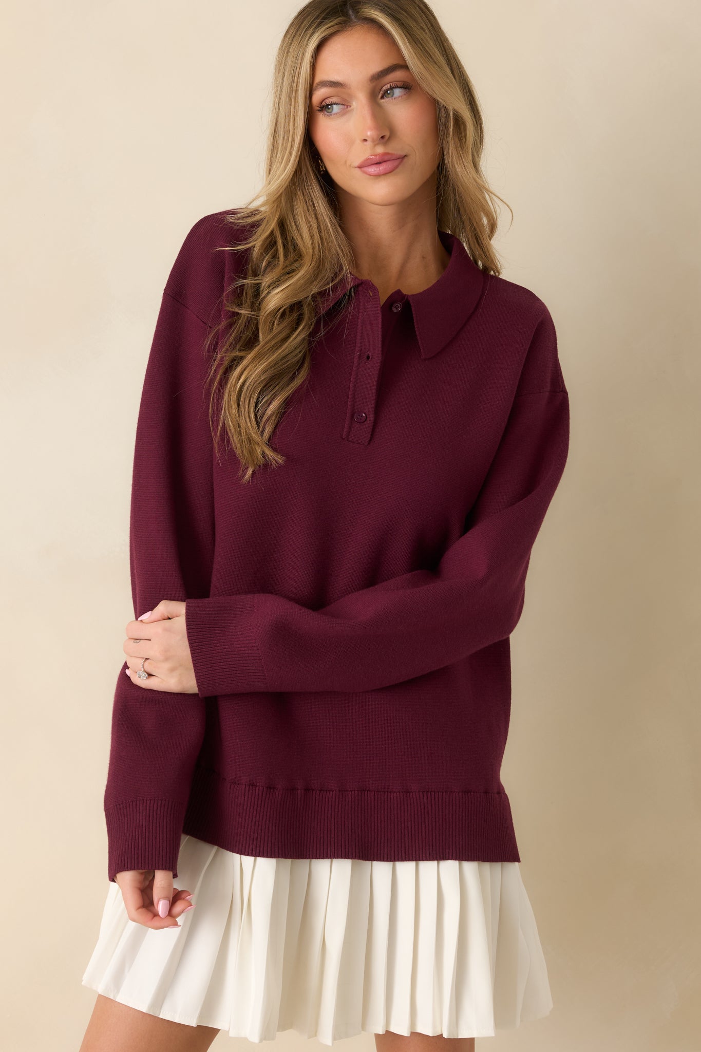 Upper torso crop focusing on collared neckline, partial button closure, and ribbed shoulder area.