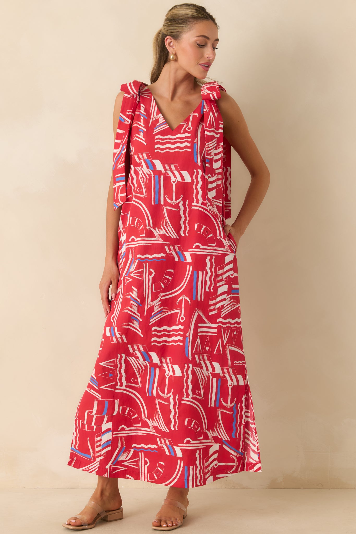 Cotton maxi dress showcasing a flattering V-neckline, wide straps with tie bows, side slits, and effortless movement.