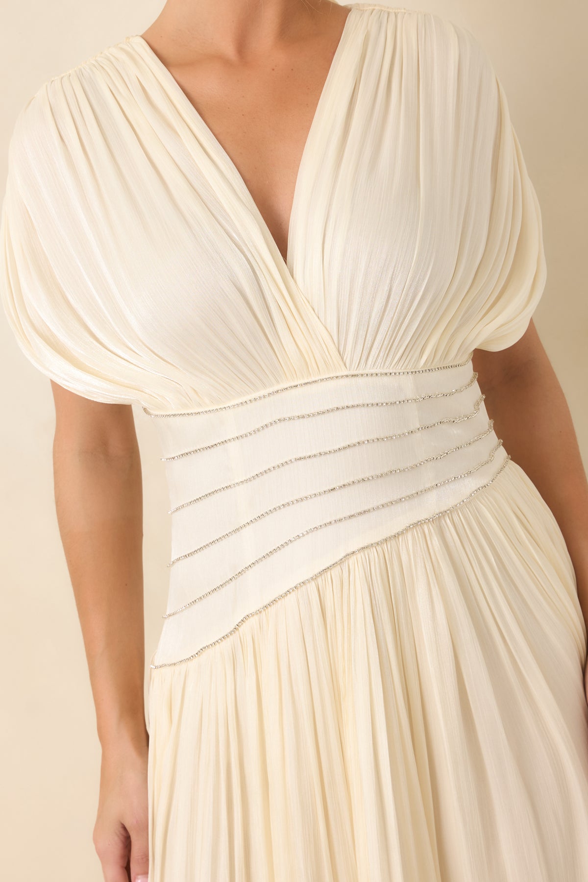 Wide velvet waist panel decorated with multiple rows of rhinestones, bordered by gathered fabric and an angled skirt seam.